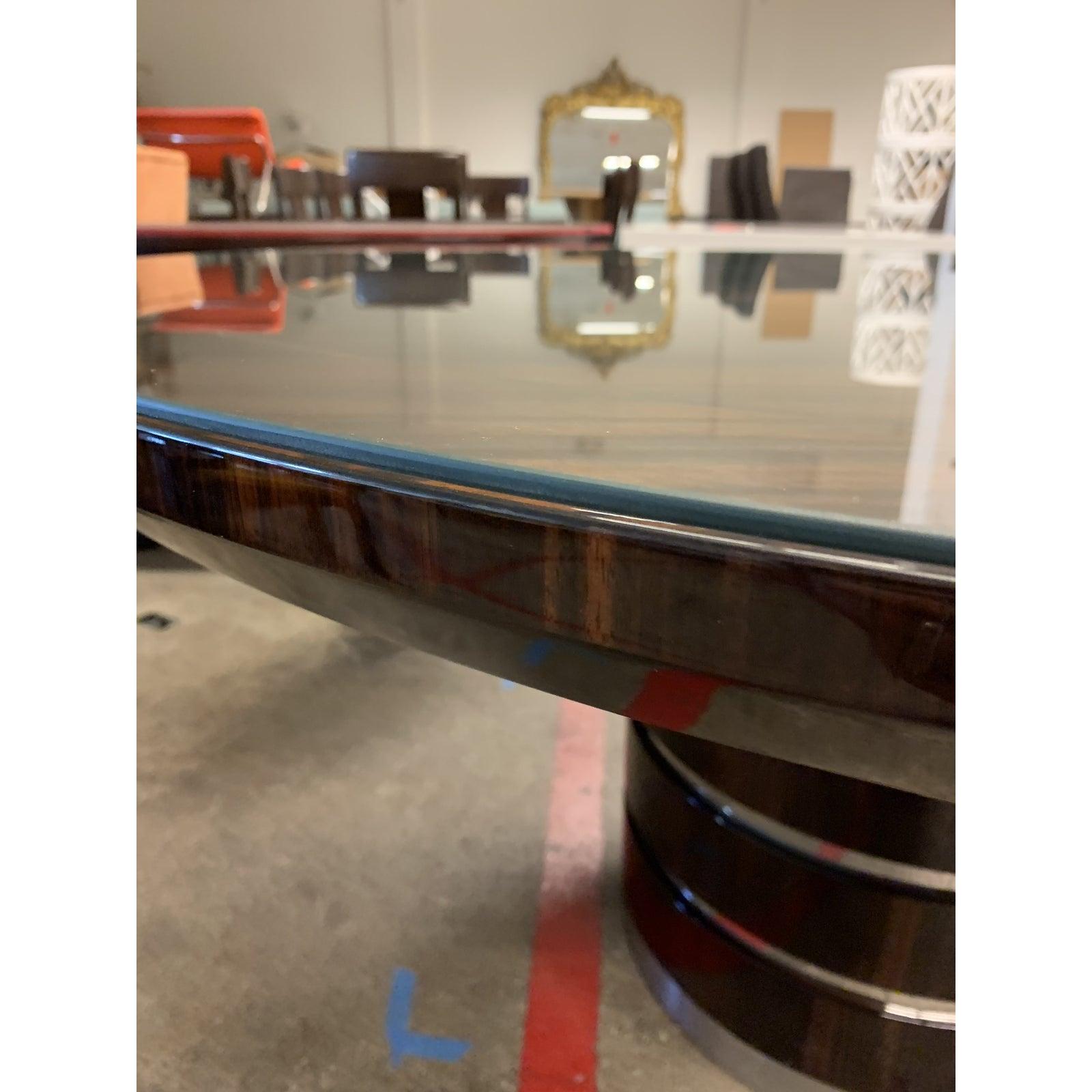 A round table by Giorgio. From the Luna collection. A round dining table with inlay top in ebony Macassar with 6mm filet in Zebra veneer in high gloss polyester. Brushed and chrome stainless steel details on the table’s legs. A custom cut glass sits