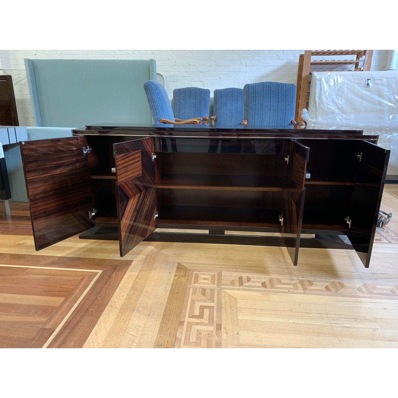 A buffet by Giorgio Furniture. From the Luna collection. An Art deco buffet in ebony Macassar with 6mm filet in zebra veneer in high gloss polyester. Two center inlay veneer doors with one full extension drawer and one bottom velvet inside, also
