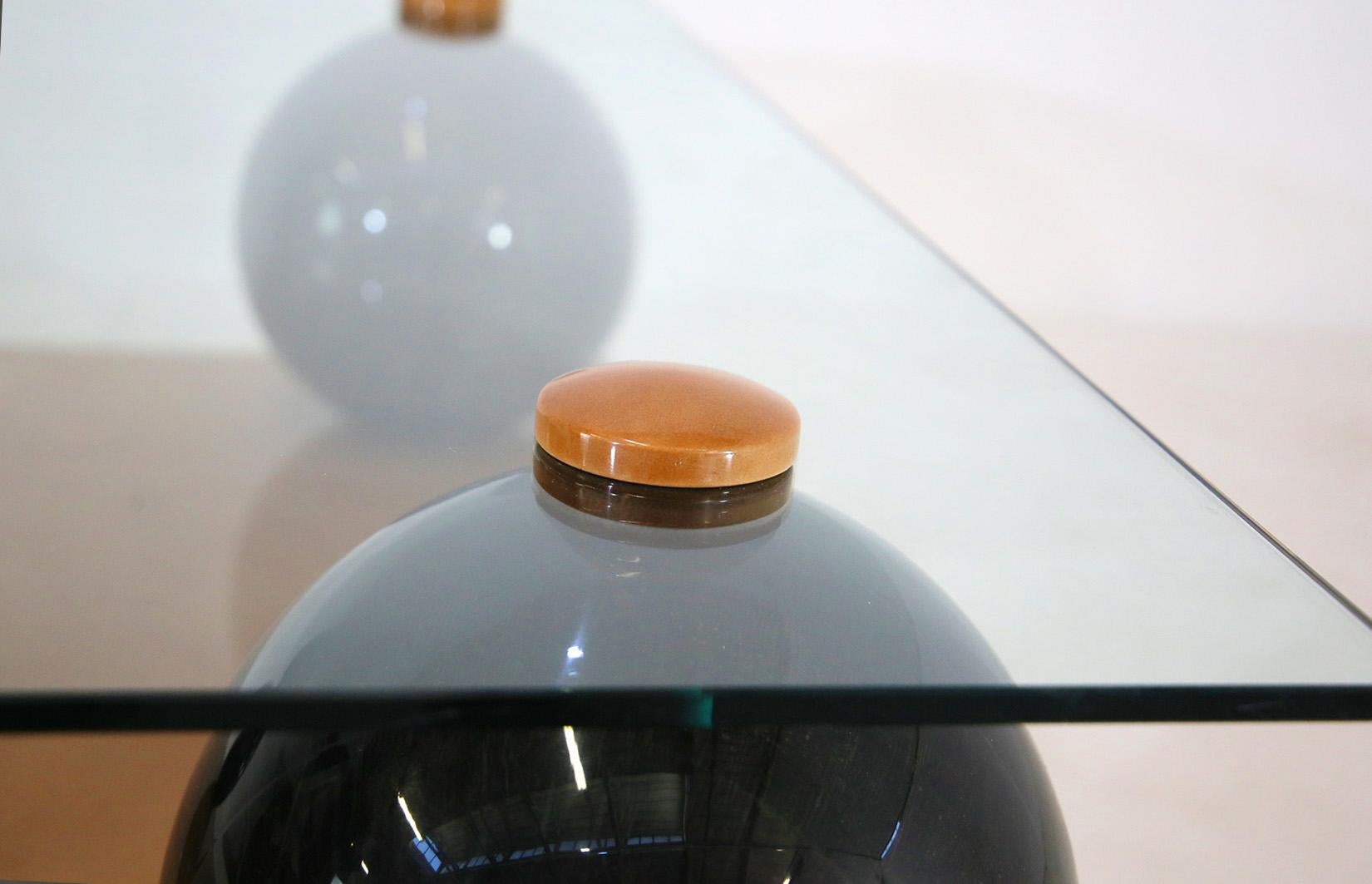 Wood, parchment and glass coffee table designed by Giorgio Tura. 
The table has a square frame. The base is made of dark wood and supports a parchment base, which gives it a pompous and elegant look.
The base is connected to the glass by four