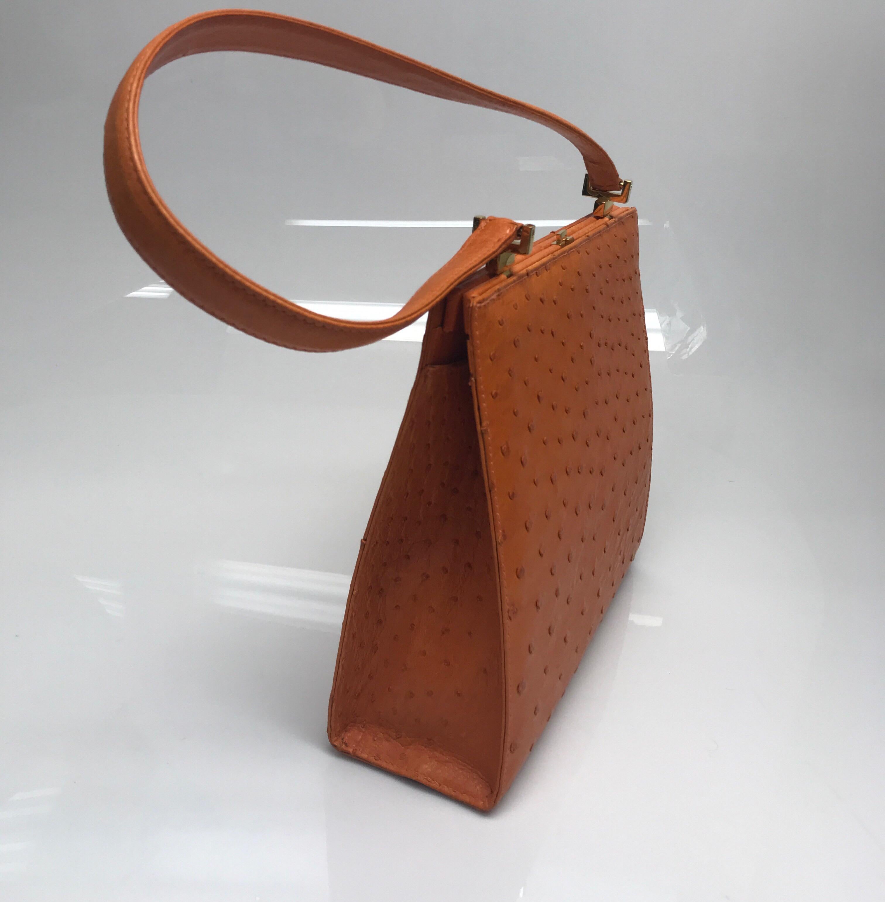 Giorgio's Palm Beach Orange Klein Karoo Ostrich Leather Purse. This beautiful Giorgio's Palm Beach purse is in excellent condition, it is brand new. It is made of orange ostrich leather and has gold hardware. There is one top handle. The purse is