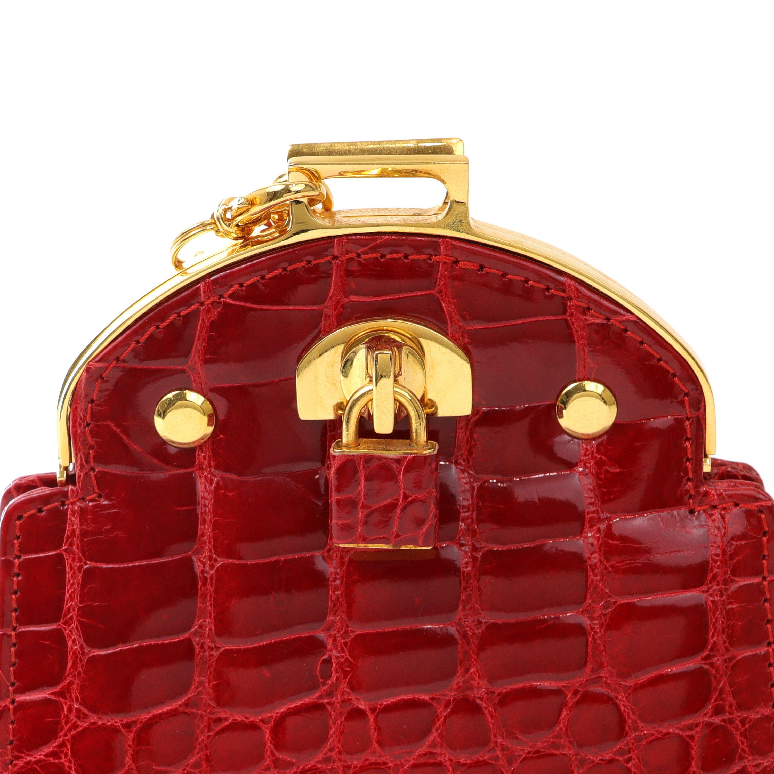 This authentic Giorgio’s Red Crocodile Mini Evening Bag is in beautiful vintage condition.  Striking red crocodile skin with gold hardware accents and padlock detail. Leather and chain entwined long shoulder strap.   Dust bag included.

PBF 14018