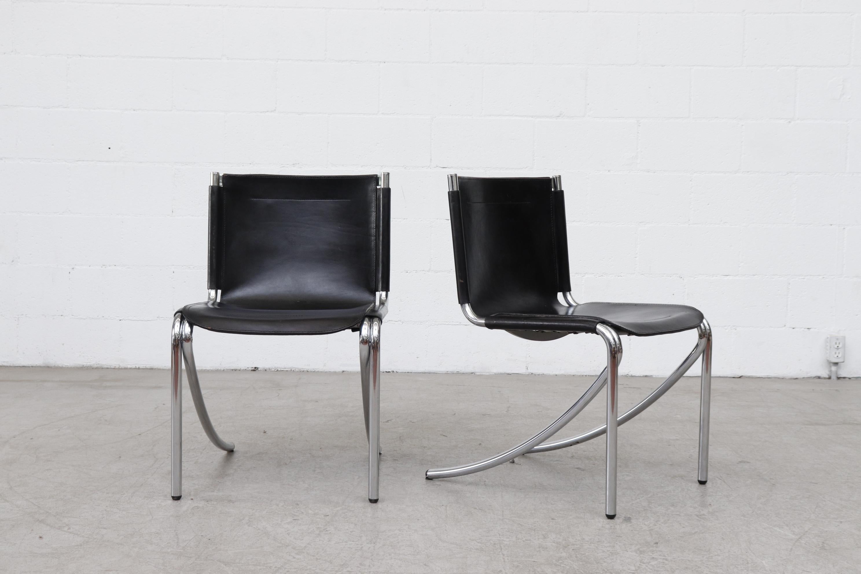 Midcentury Giotto Stoppino black leather cantilevered dining chairs with tubular chrome frames and curved leg design. Designed in 1976, these 