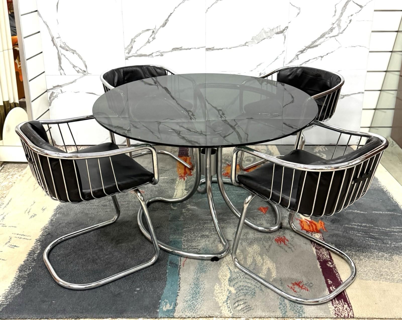 Wonderful dining set composed as follows:


Iconic dining table designed by Giotto Stoppino in the 1970s, an emblem of Italian design of the period. The structure is made of tubular chromed steel, with a sinuous and dynamic base that weaves in a