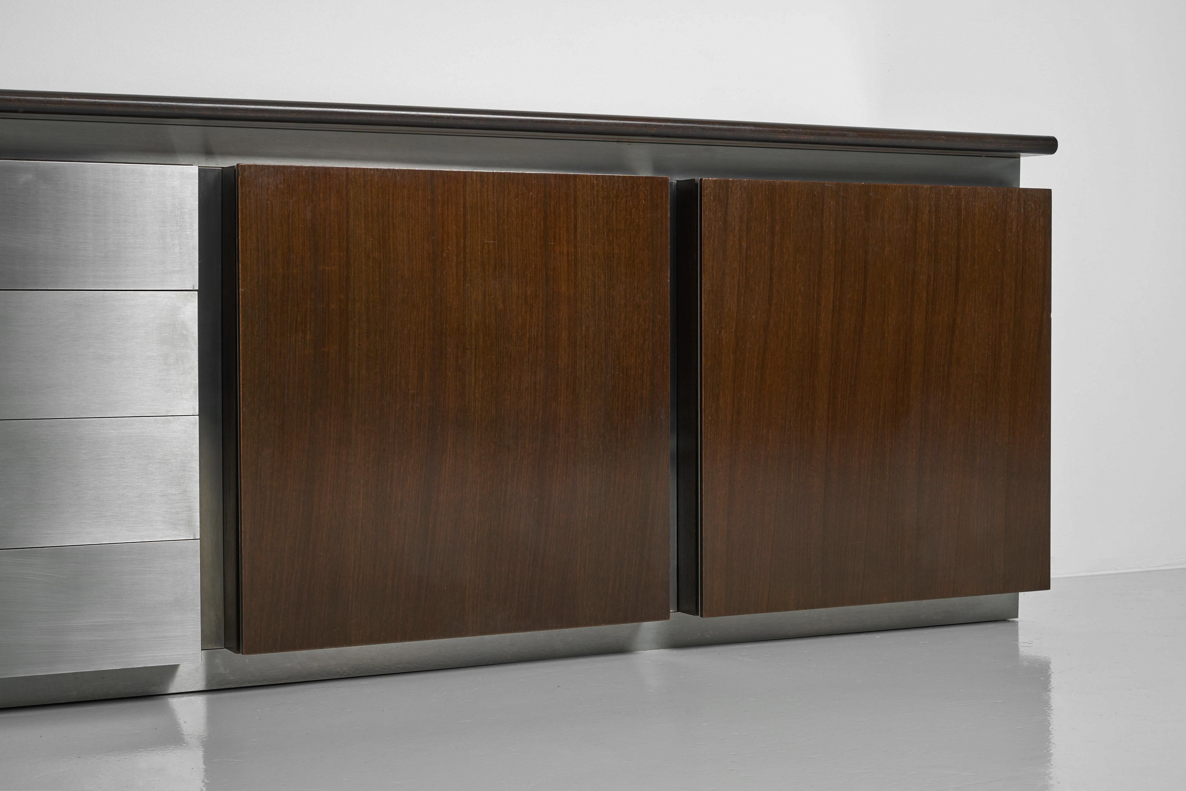Large Gouju sideboard designed by Giotto Stoppino and manufactured by Acerbis in Italy 1977. This remarkable piece combines mahogany wood with stainless steel, creating a beautiful and eye-catching blend of materials. The sideboard features four