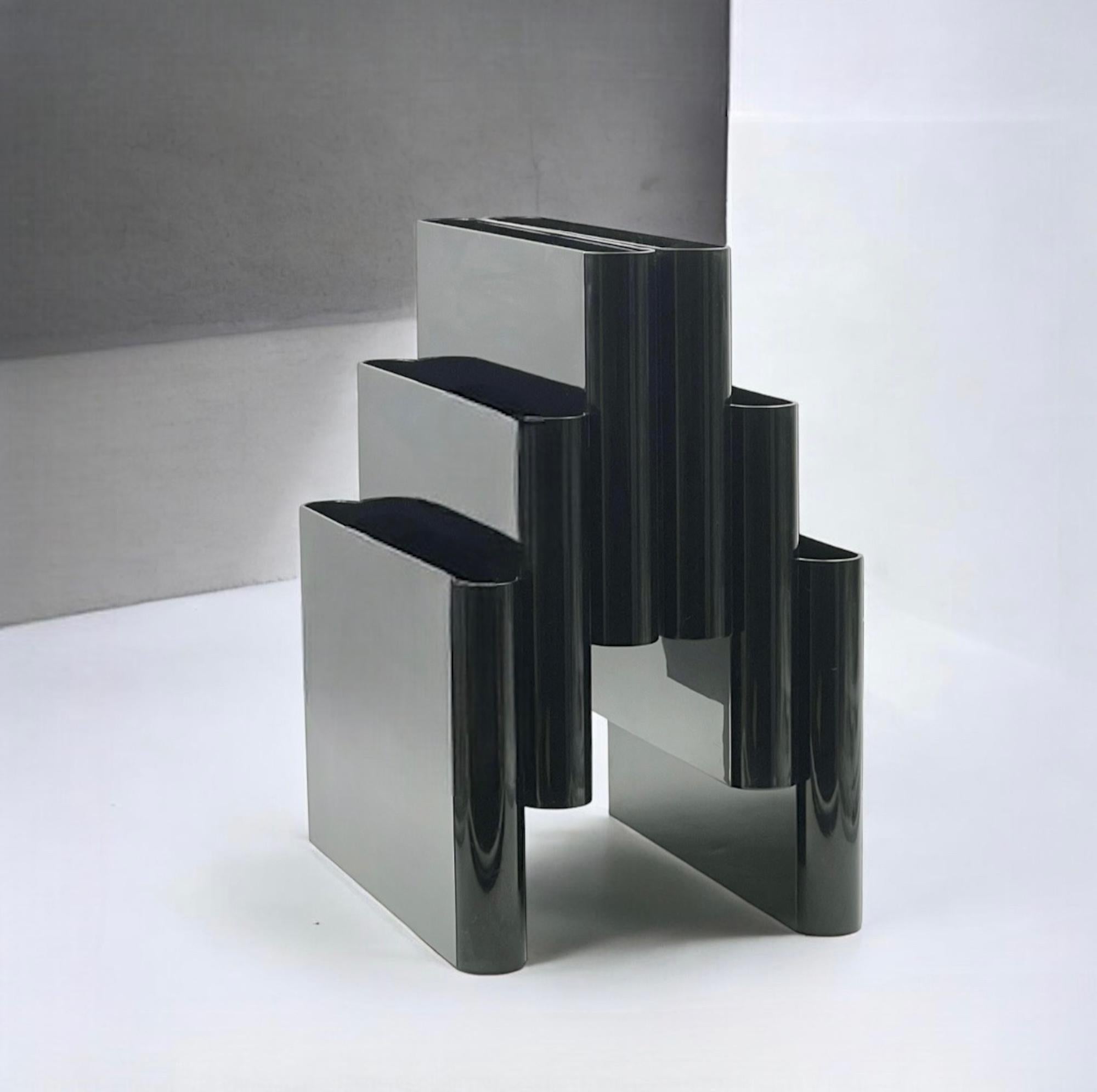 Explore the epitome of 1970s Italian design with this stunning ‘Model 4765’ Kartell magazine rack. designed by the renowned Giotto Stoppino in 1972. This piece is a perfect blend of functionality and aesthetic brilliance, embodying the innovative