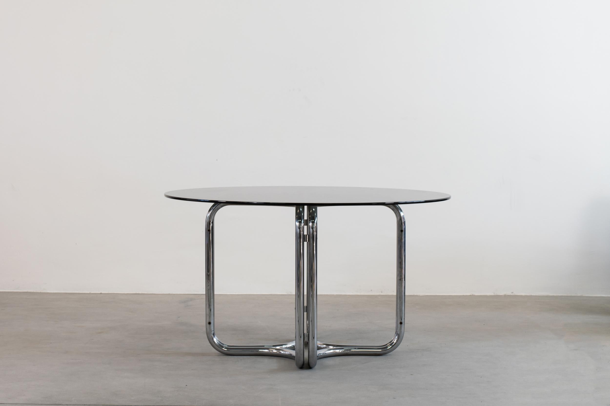 A round-shape dining table with a steel base and glass on top, designed by Giotto Stoppino, Italian Manufacture, 1970s.

Giotto Stoppino has been one of the architects that inspired the Neoliberty, the architectural movement that – in the 50s –
