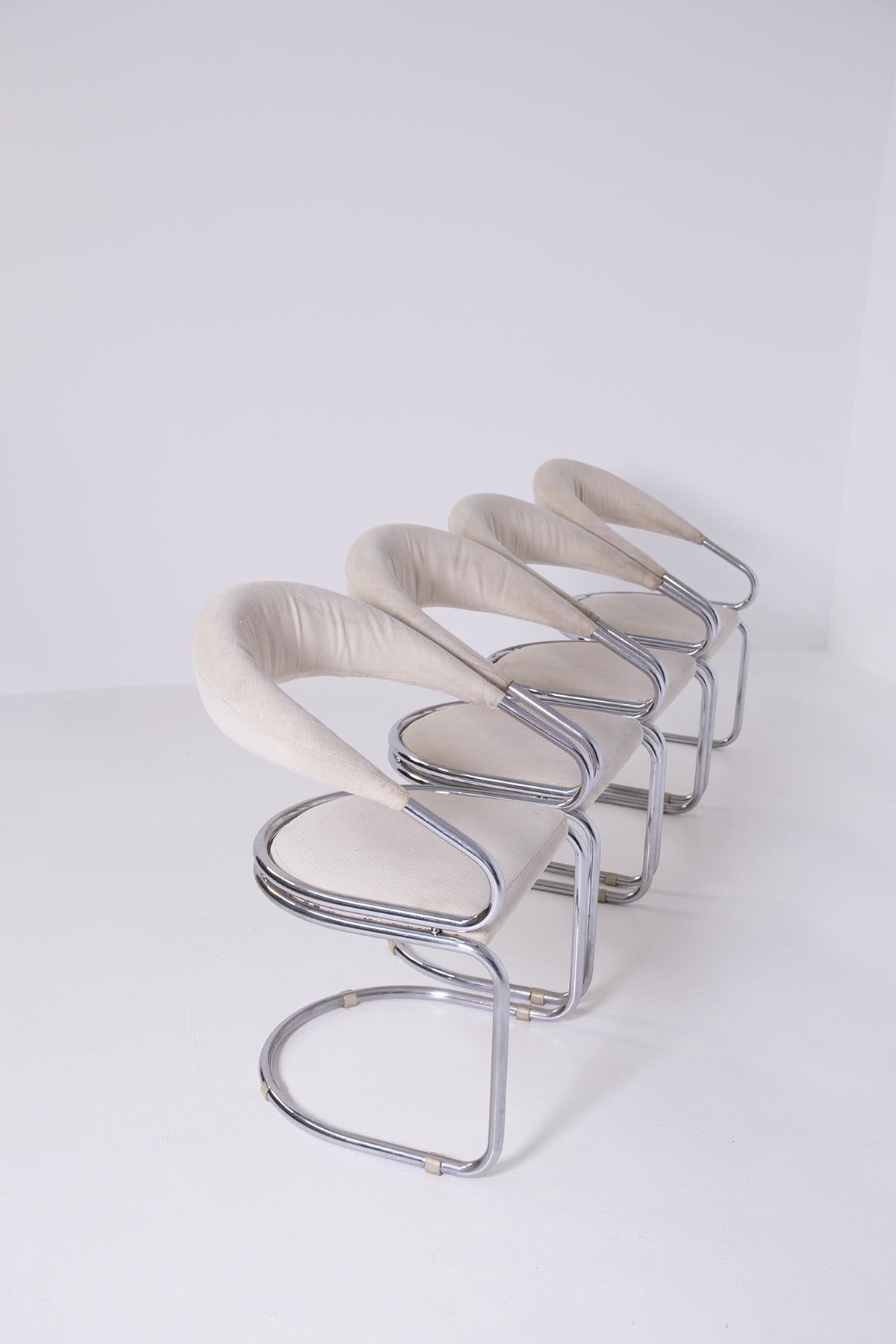 Italian chair set composed of 4 chairs made by architect Giotto Stoppino from the 1960s.
The set is made of chrome plated tubular steel. Its wavy and soft lines create elegance and charm to each chair.
The seat and back are made of cotton fabric