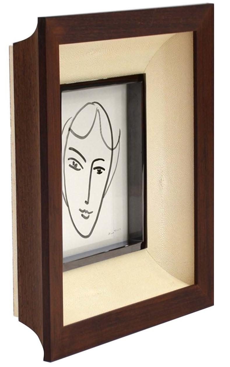 More than a decorative object, this frame will display cherished memories recorded on a photo to be remembered and admired. This elegant frame is crafted of dark wenge and showcases a wide beveled passe-partout covered in ivory shagreen and a