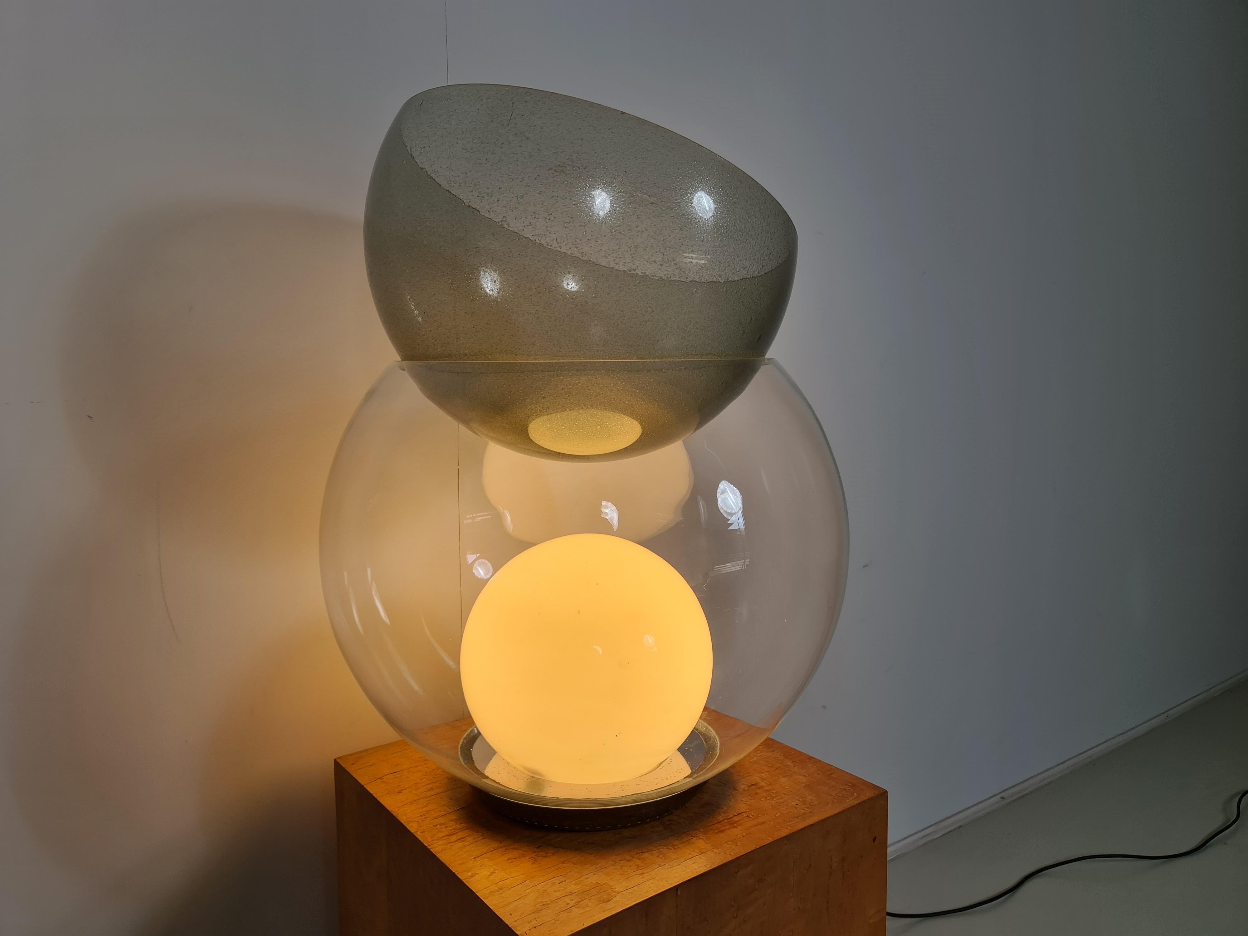 Giova table lamp by Gae Aulenti for FontanaArte, 1960. 
A luminous sculpture in glass that can be even a centerpiece to your interior. This first edition Giova give lamp has a chromed metal base. The lamp contains a middle globe in transparent