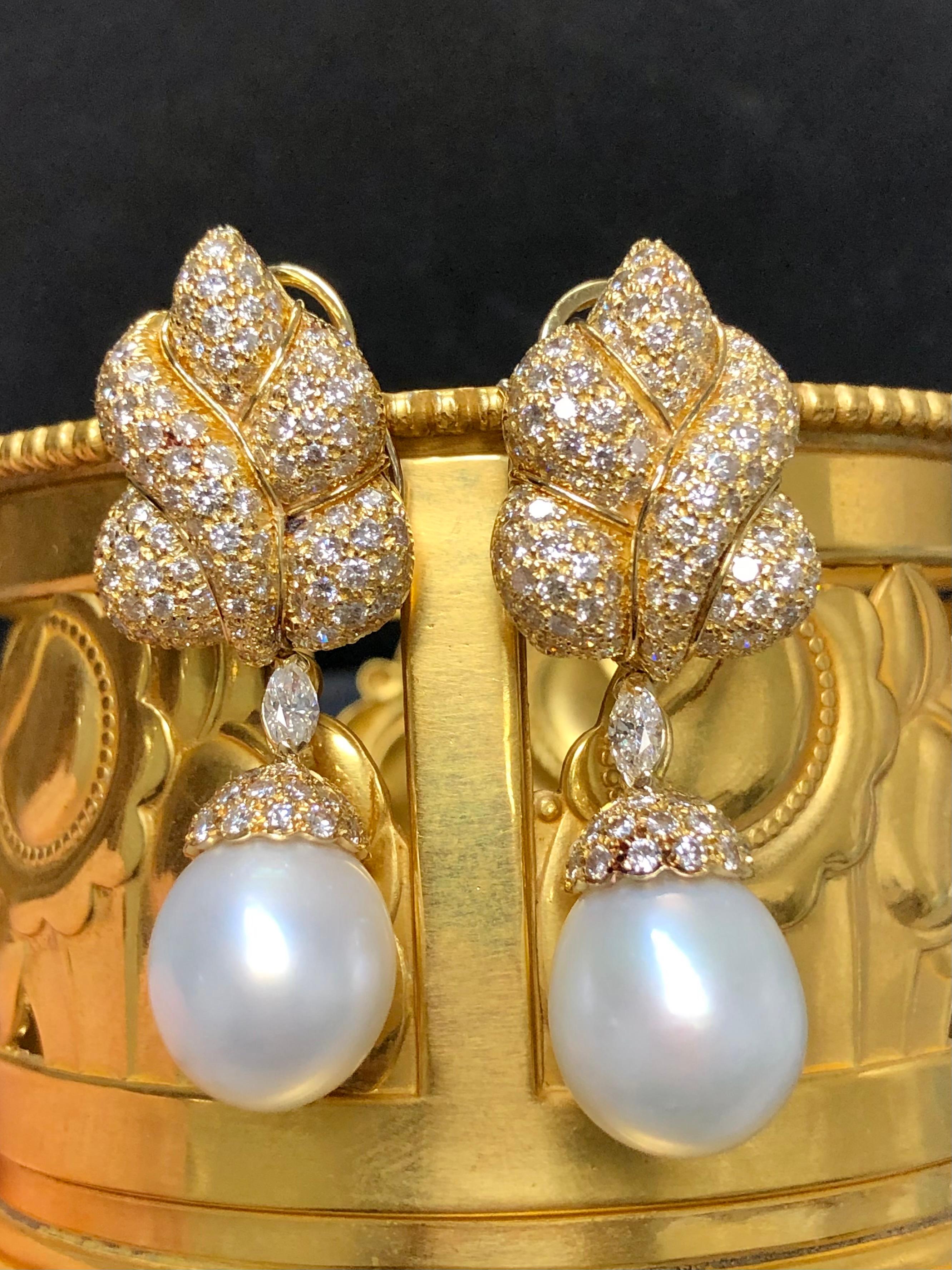 
A spectacular pair of South Sea pearl and diamond earrings by Italian designer GIOVANE. They are crafted in 18K yellow gold and set with approximately 7.60cttw in G-H color Vs1-2 clarity round and marquise cut diamonds. The pearls and marquise