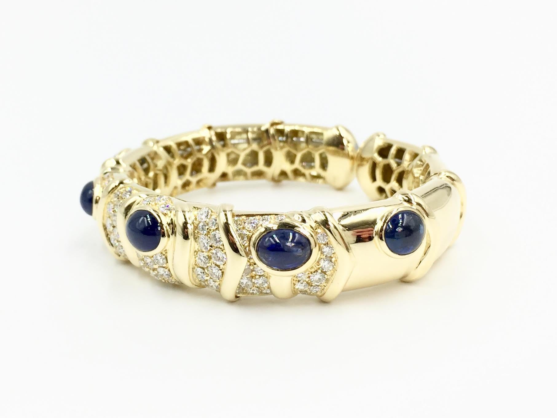 Polished 18 karat yellow gold oval cuff bracelet with five gorgeous oval cabochon blue sapphires and high quality pavé set diamonds by fine jewelry designer Giovane. Blue sapphires have a well saturated medium blue hue and a total weight of 9.14