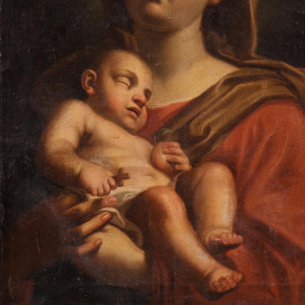 Antigua Virgen con el Niño de mediados del siglo XVII. Óleo sobre lienzo de notable calidad pictórica atribuible al pintor italiano Giovanni Andrea Sirani (1610-1670). Artista boloñés de la época barroca, fue alumno predilecto de Guido Reni y es