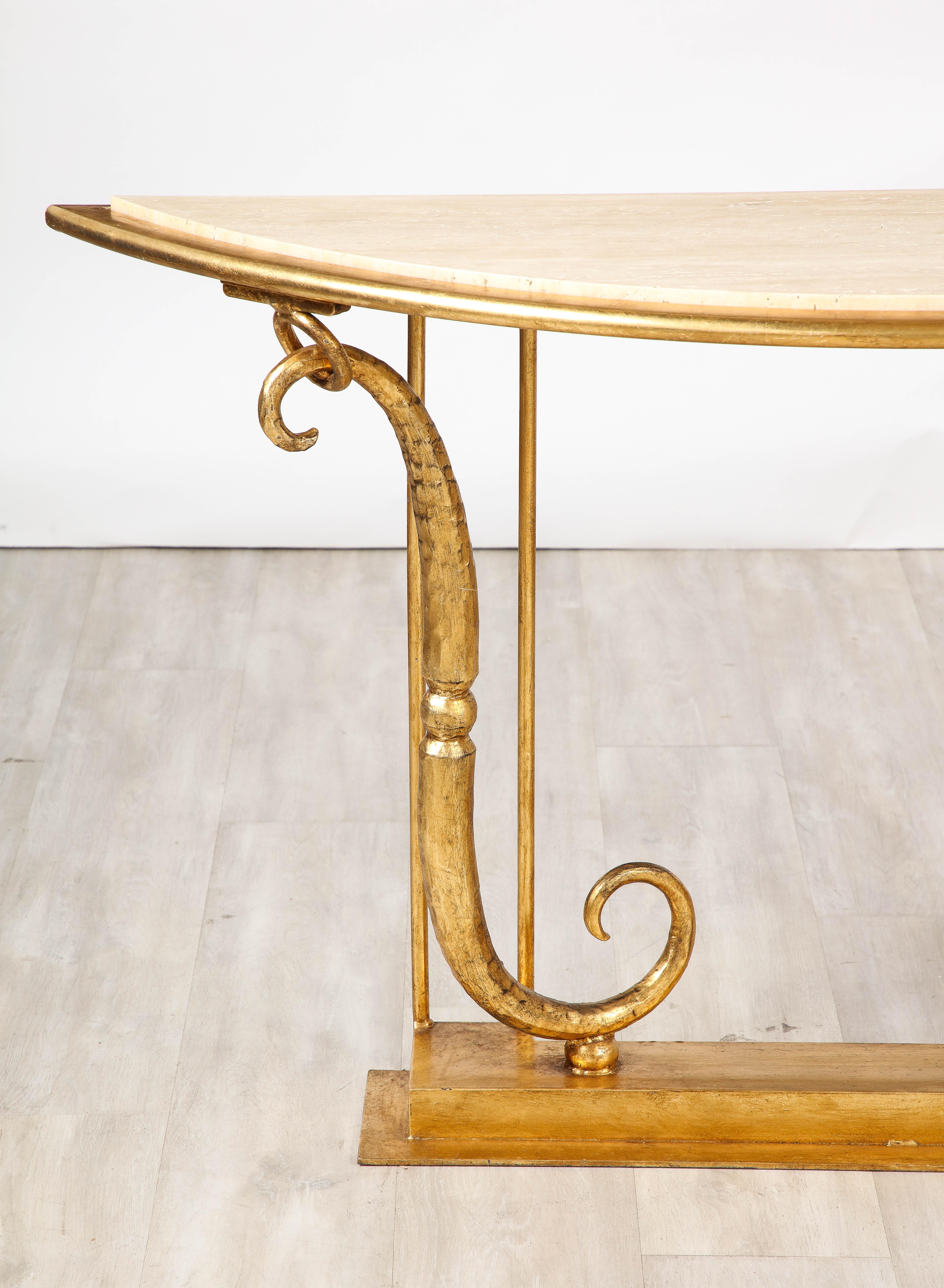 A stunning and dramatic Neoclassical inspired hand-hammered gilt iron console or sofa table by Italian sculptor and designer, Giovanni Banci, Florence, circa 1970.  The rectangular gilded iron plinth base supports the gilded iron scrolls on each end
