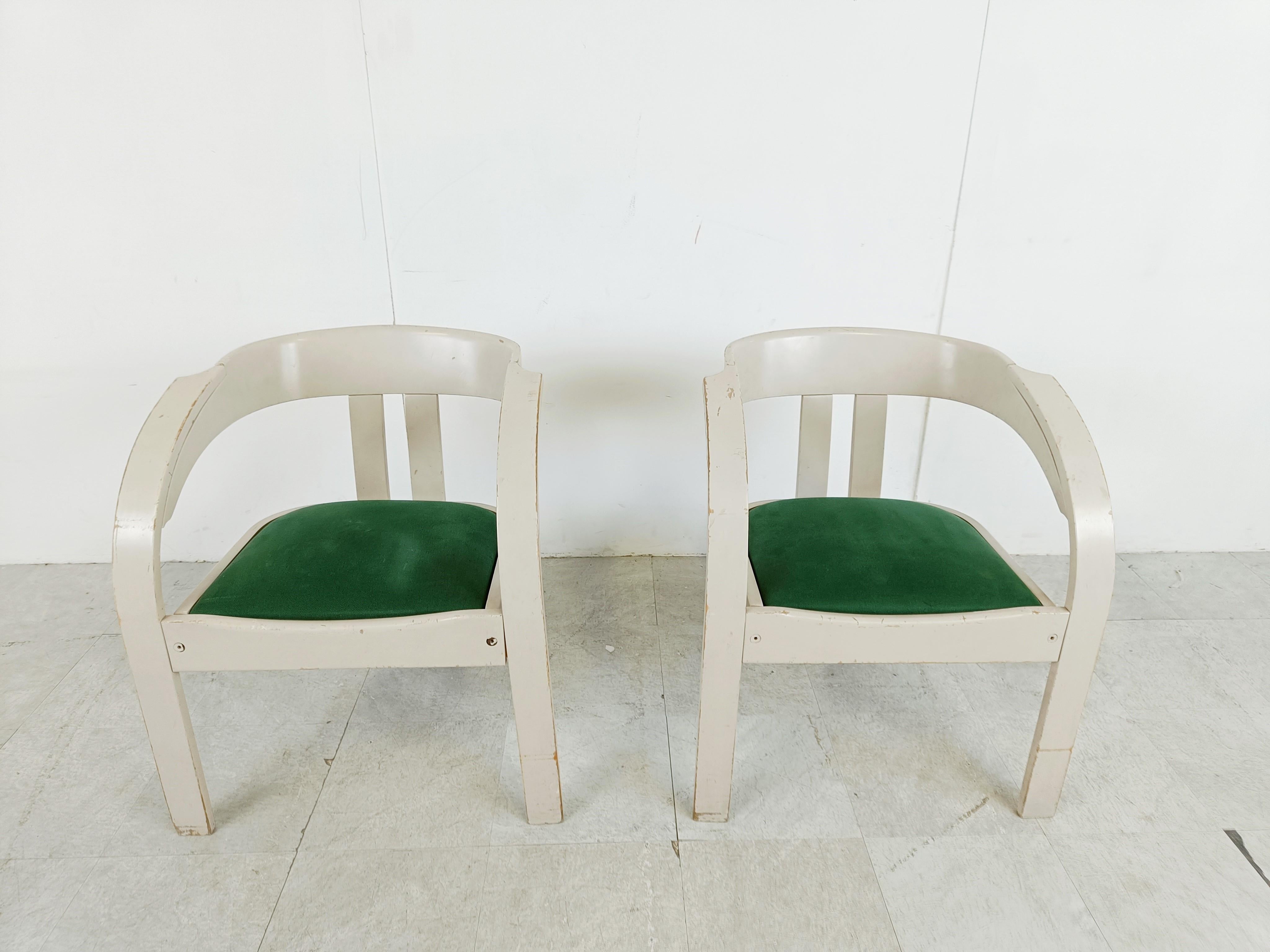 Original mid century armchairs by Giovanni Battista Bassi for Poltronova. 

These model 'Elisa' armchairs consist of a grey lacquered wooden frame and green velvet seats.

The frames are left in unrestored original condition with visible wear.

We