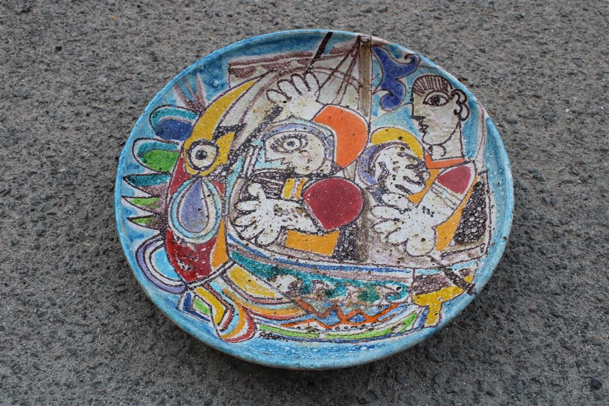 Giovanni De simone 1970s ceramic plate with slaughter of multicolored fish and fishermen.