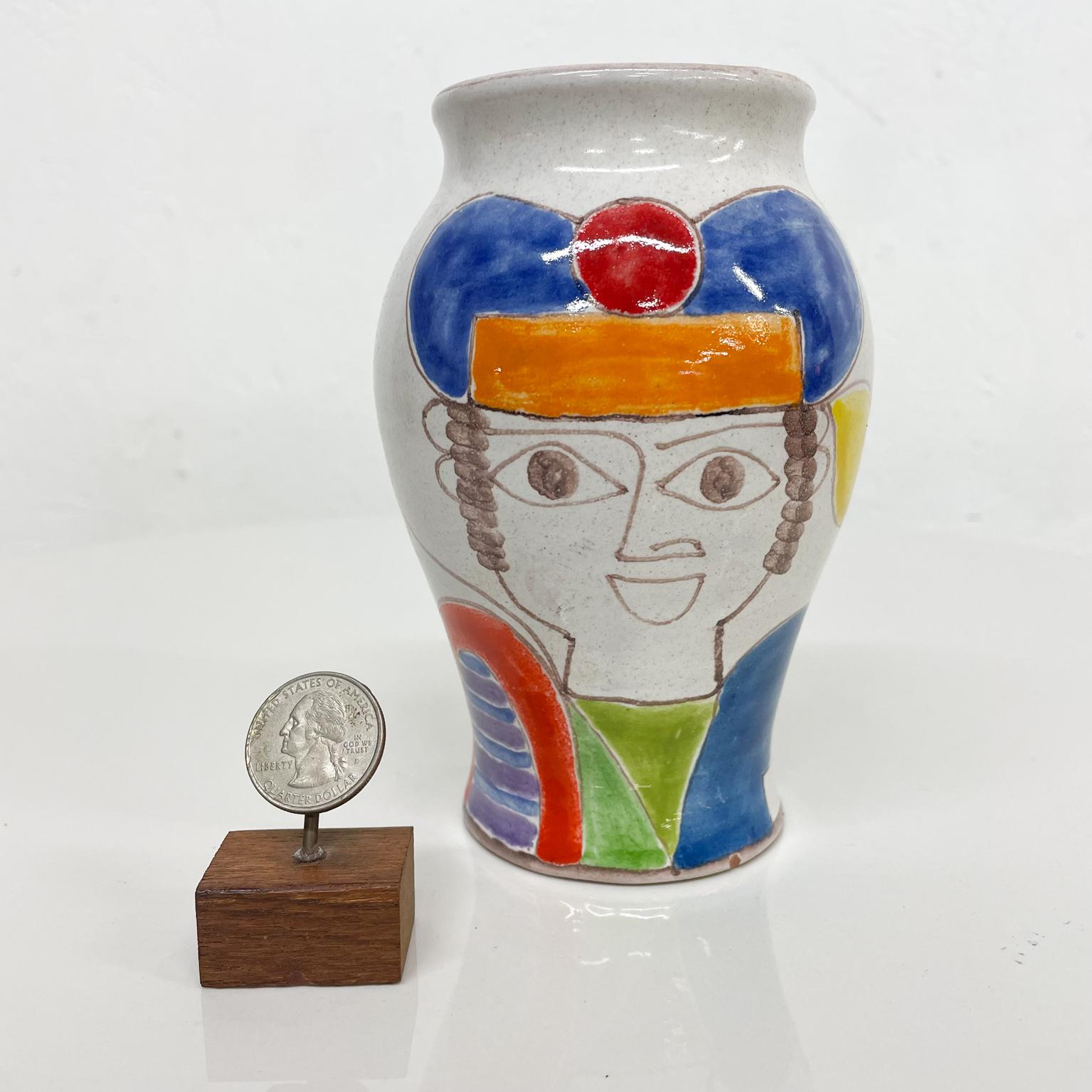 Italian pottery vase.
from Italy DeSimone hand painted ceramic pottery vase.
Giovanni De Simone Italian colorful vase 1960s Italy.
Measures: 5.63 tall x 3.75 diameter
Preowned original unrestored good vintage condition.
See images provided.
 