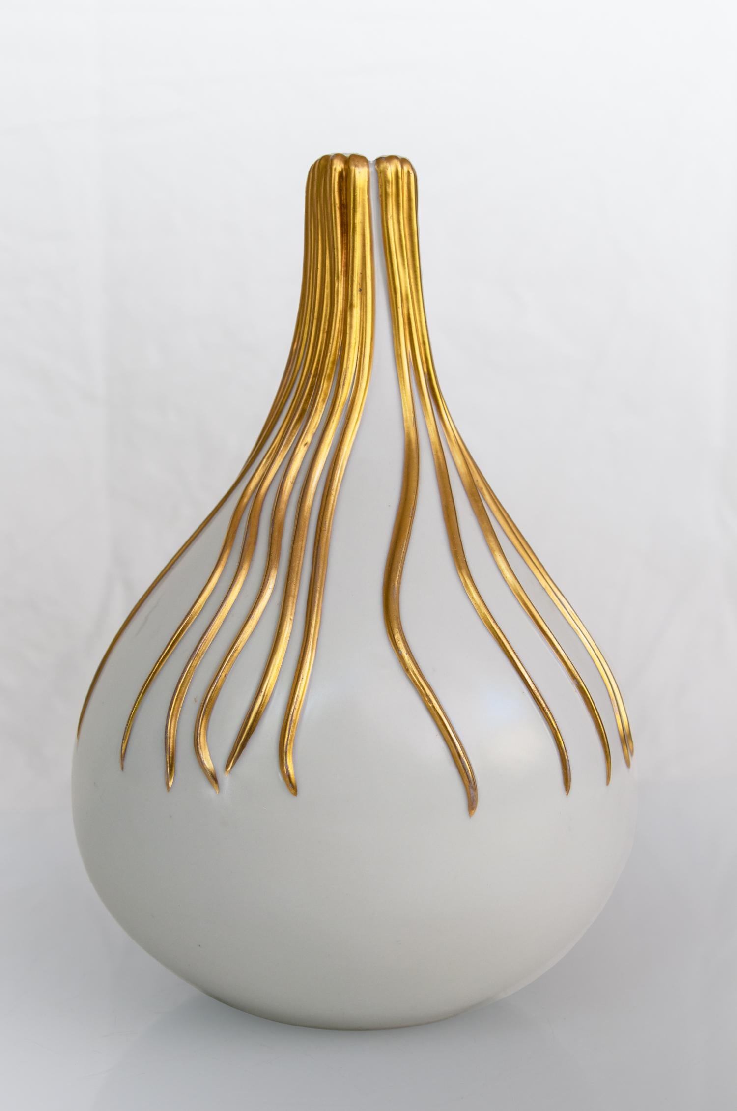 Ceramic vase designed by Giovanni Gariboldi in the 1930's for Richard Ginori, San Cristoforo, Italy.

Bulbous white ceramic vase with a small opening and gold gilding.
Richard - Ginori, one of the most famous porcelain factories in the world,