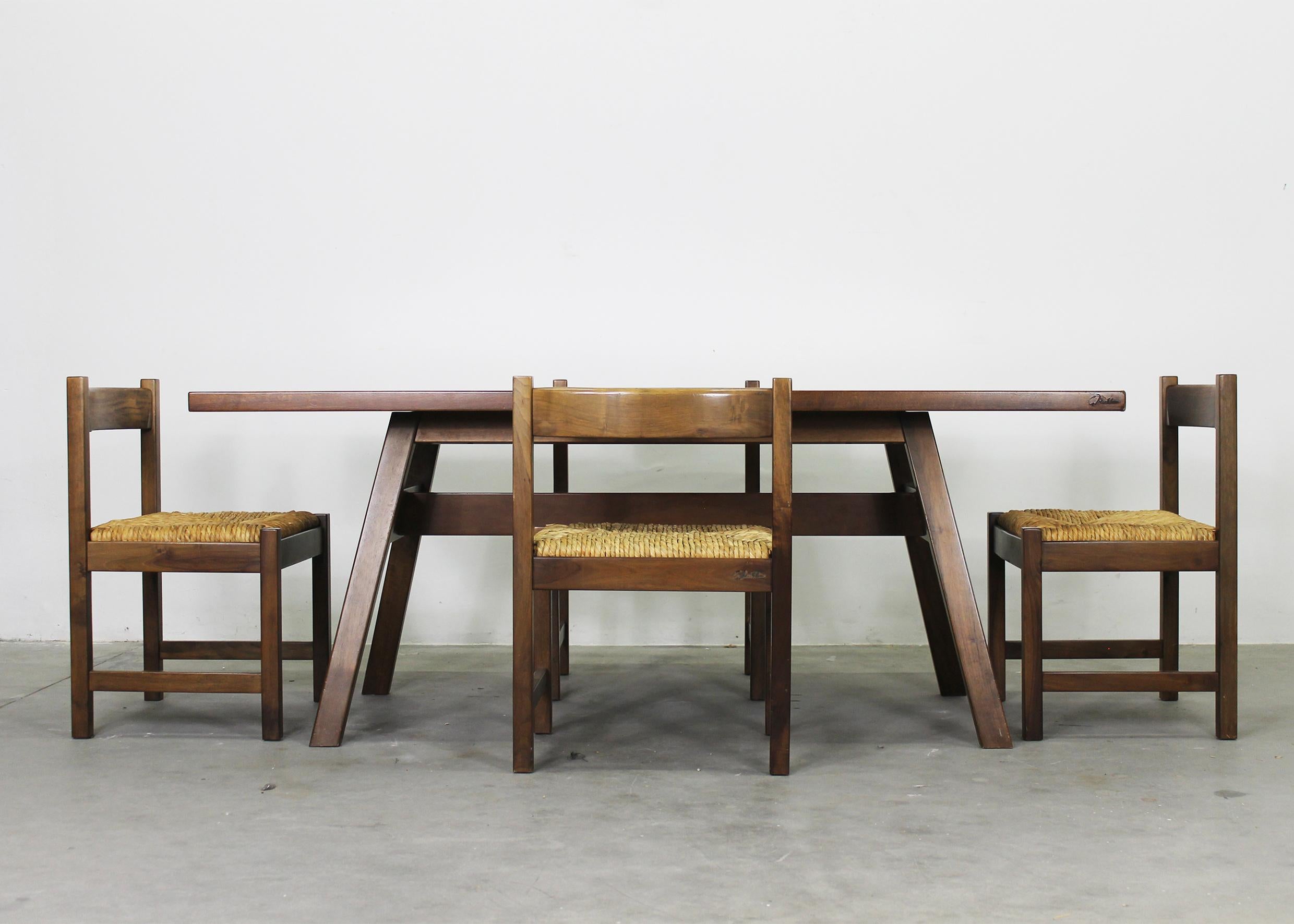 Torbecchia dining room set composed of four chairs, one table, and one bench.
The table and the bench were made in walnut wood, the chairs have a structure in walnut wood and woven seats. 

Each piece of this set came from the Torbecchia series