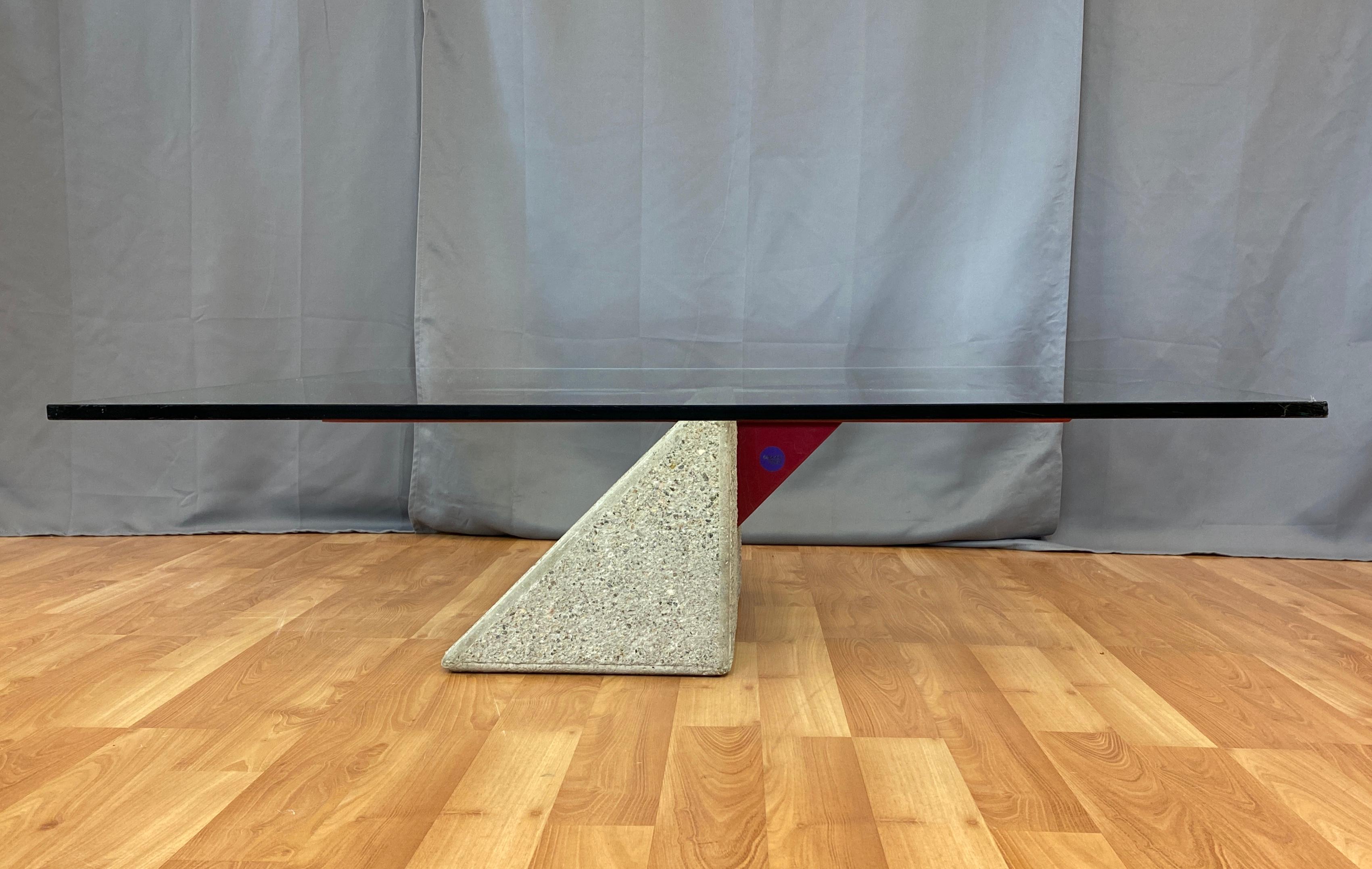 A circa 1980s concrete, red tubular and red flat metal for the base, with a large glass top, coffee table. 
Designed by Giovanni Offredi for Saporiti Italia 

The base is 14in x 22 3/8in, glass is 1/2in thick