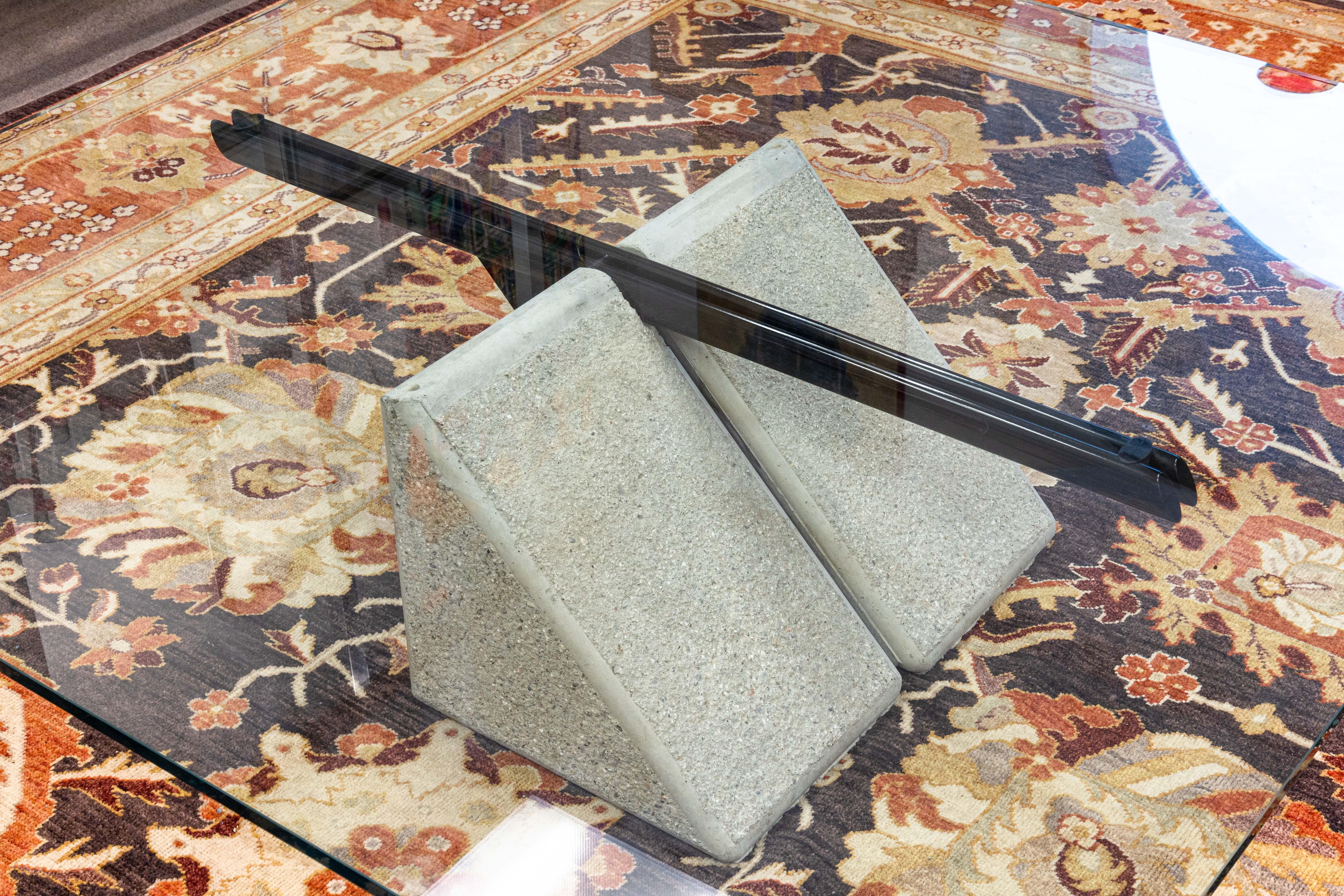 A Giovanni Offredi for Saporiti concrete and glass coffee table. This is a beautiful piece of contemporary modern design. This coffee table freatures a large square table top with a thick glass, and a concrete and metal base. This base is has a