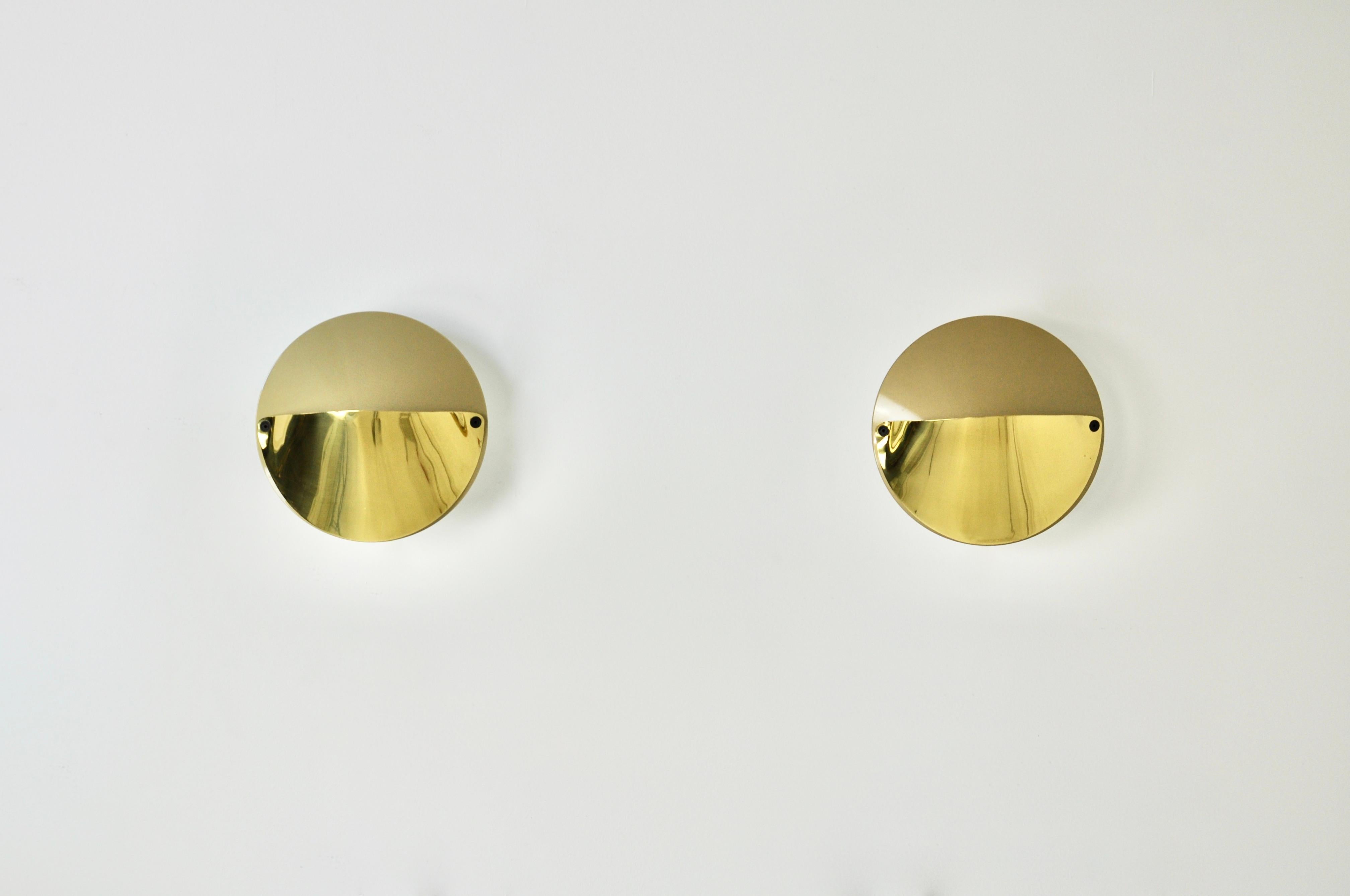 Pair of gold coloured metal sconces by Achille Castiglioni. Stamped Flos. Wear due to time and age of the sconces.