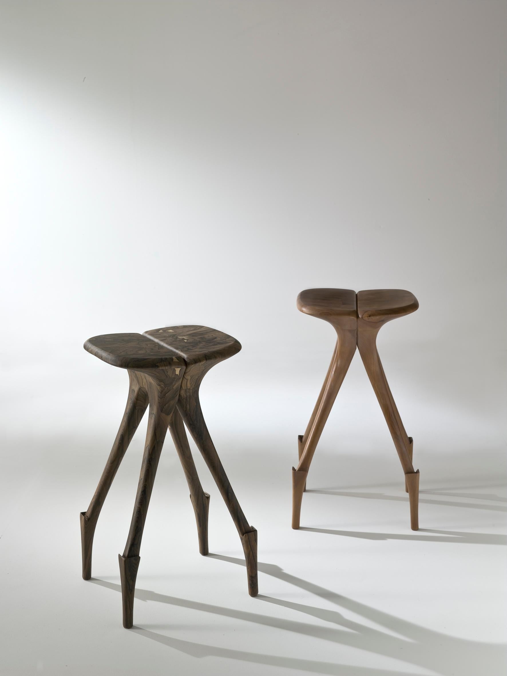 The grace and elegance of the giraffe find expression in the form of a meticulously handcrafted walnut heartwood stool. Inspired by the untamed beauty of Africa, this stool is a true embodiment of nature's allure and artistic refinement.

Crafted