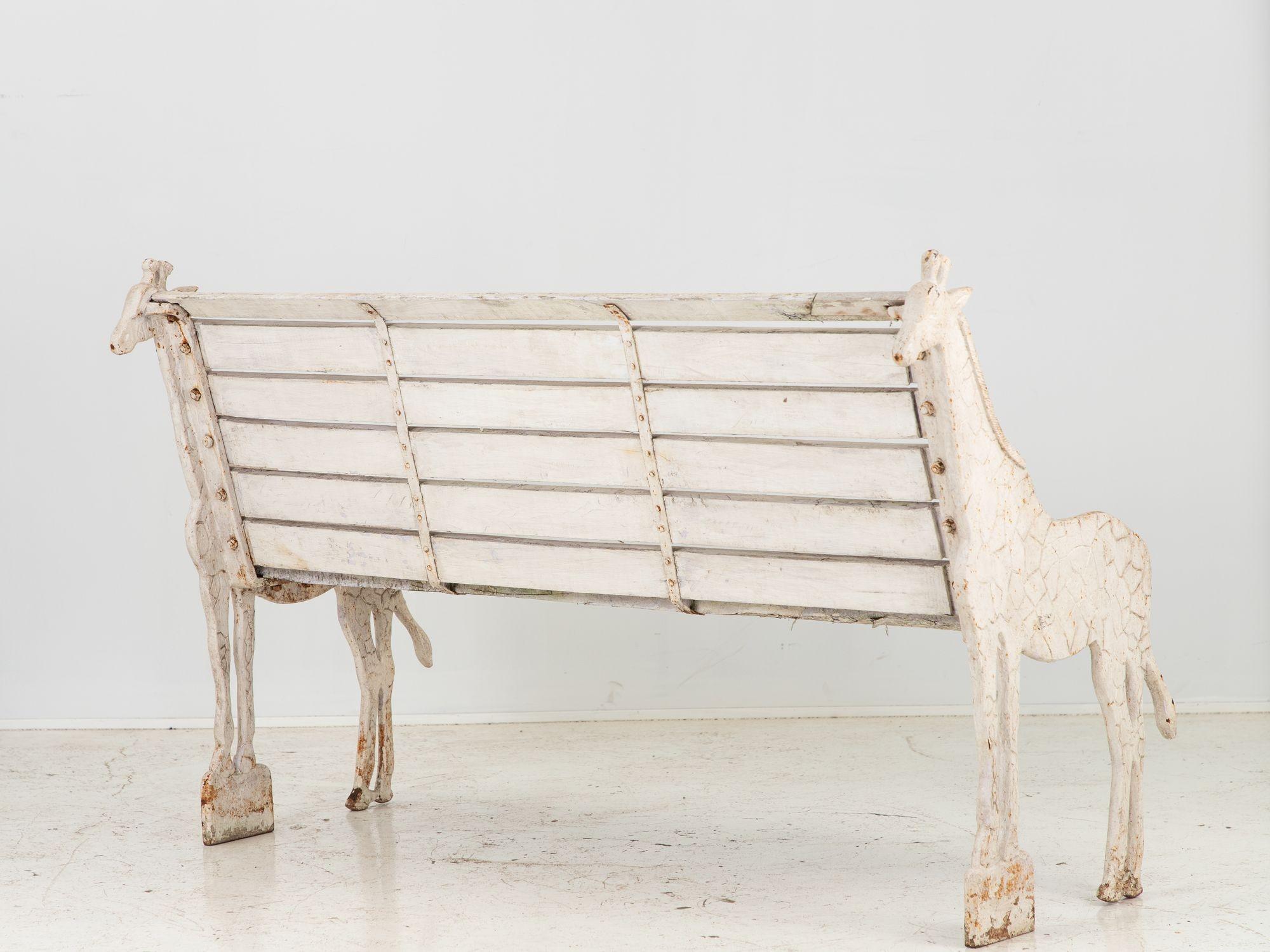 Originally made for the Colchester Zoo in England, this garden bench is a delightful piece of outdoor furniture with a charming giraffe design. The bench features a sturdy wooden seat and backrest that provide comfortable seating. The bench's unique