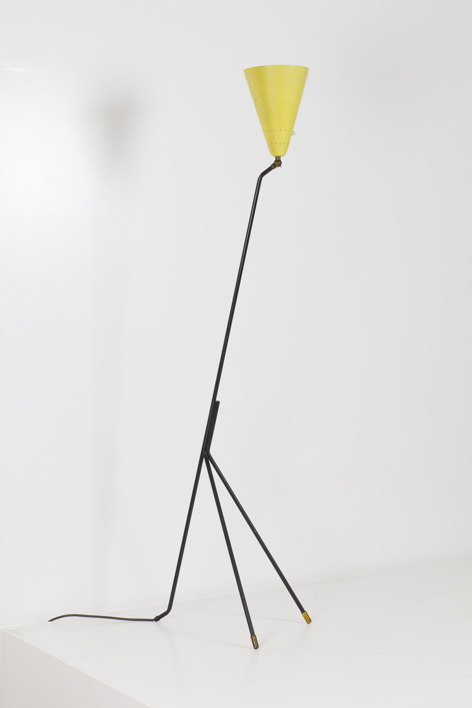 Giraffe style three-legged lamp with black powder coated steel legs and conical yellow perforated shade by Svend Aage Holm Sorensen. Shade can be tilted upwards for use as a torchiere or downward for reading.