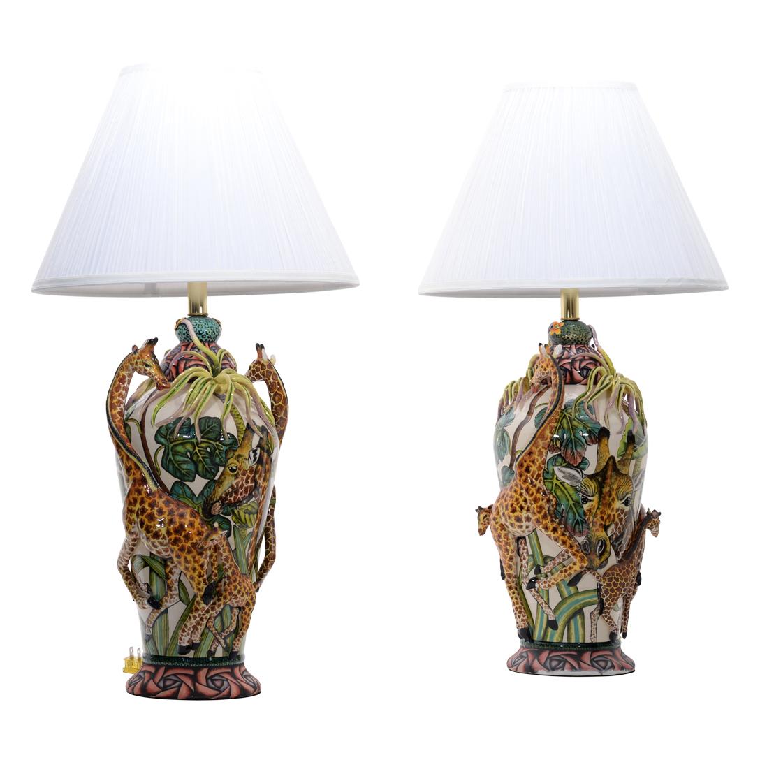 Designed by Senzo Duma Ceramics, this exquisite giraffe lamp pair is a true work of art, sculpted by master artisan Thabiso and hand-painted by Junoth in South Africa. Each lamp showcases two beautifully sculpted giraffes, elegantly intertwined
