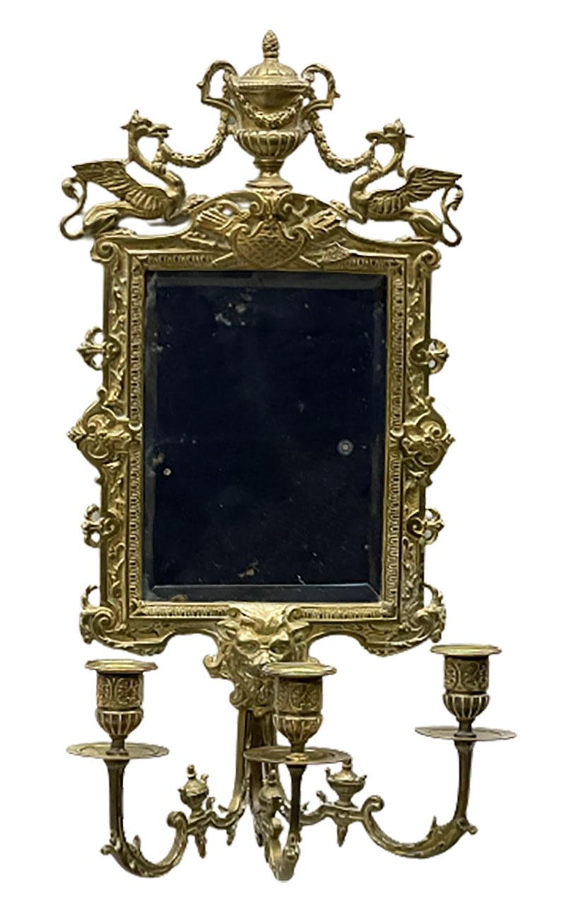 Girandole mirrors with 3-armed candleholders, circa 1900.

Girandole mirrors with 3-armed candleholders. The decoration at the top with an ornamental vase in the middle with a griffin on each side. The 3 arms of the candleholders meet in the