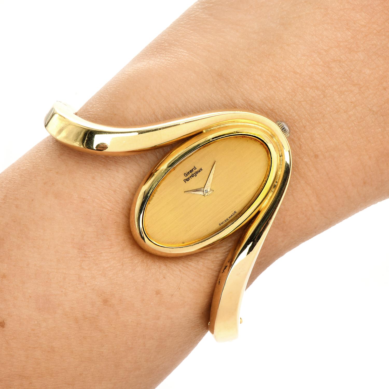 This Vintage 1980s Girard  6  solid gold bangle watch.

This collectible Vintage piece is crafted in highly polished 18K Yellow Gold, weighing 77.0 grams and measuring: 6” around the wrist.

An inversed oval, wave bangle watch, with a unique and