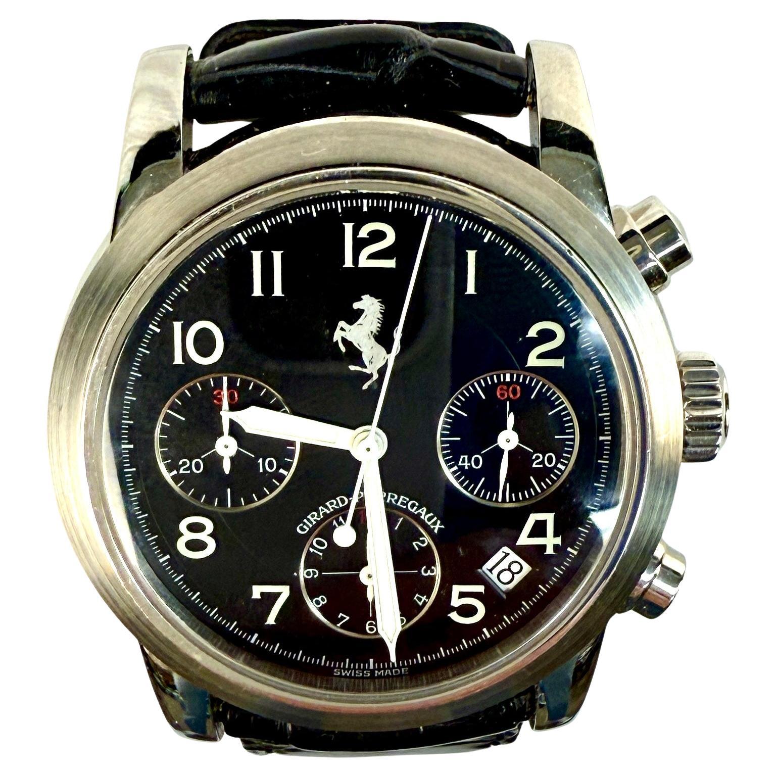 Girard Perregaux 8020 Ferrari Chronograph Black Dial Men's Watch with stainless steel 38mm case and black crocodile leather strap. Watch strap is 9 inches in length. Tang buckle on strap. Black Arabic dial with luminous hands. Date window between 4