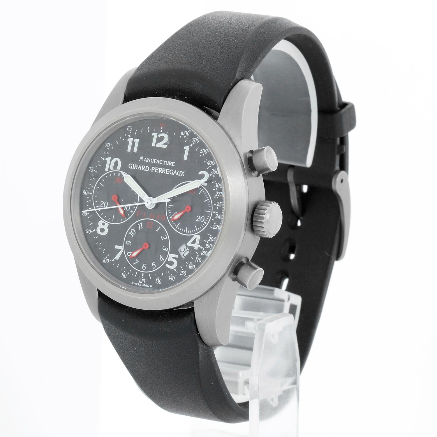 Girard Perregaux Ferrari F1 048 Men's Titanium Watch 4955 - Automatic winding, chronograph. Titanium case (40mm diameter) Original finish . Black Carbon Fiber dial with Arabic numerals, date between the 4 & 5 o'clock position. Girard-Perregaux black