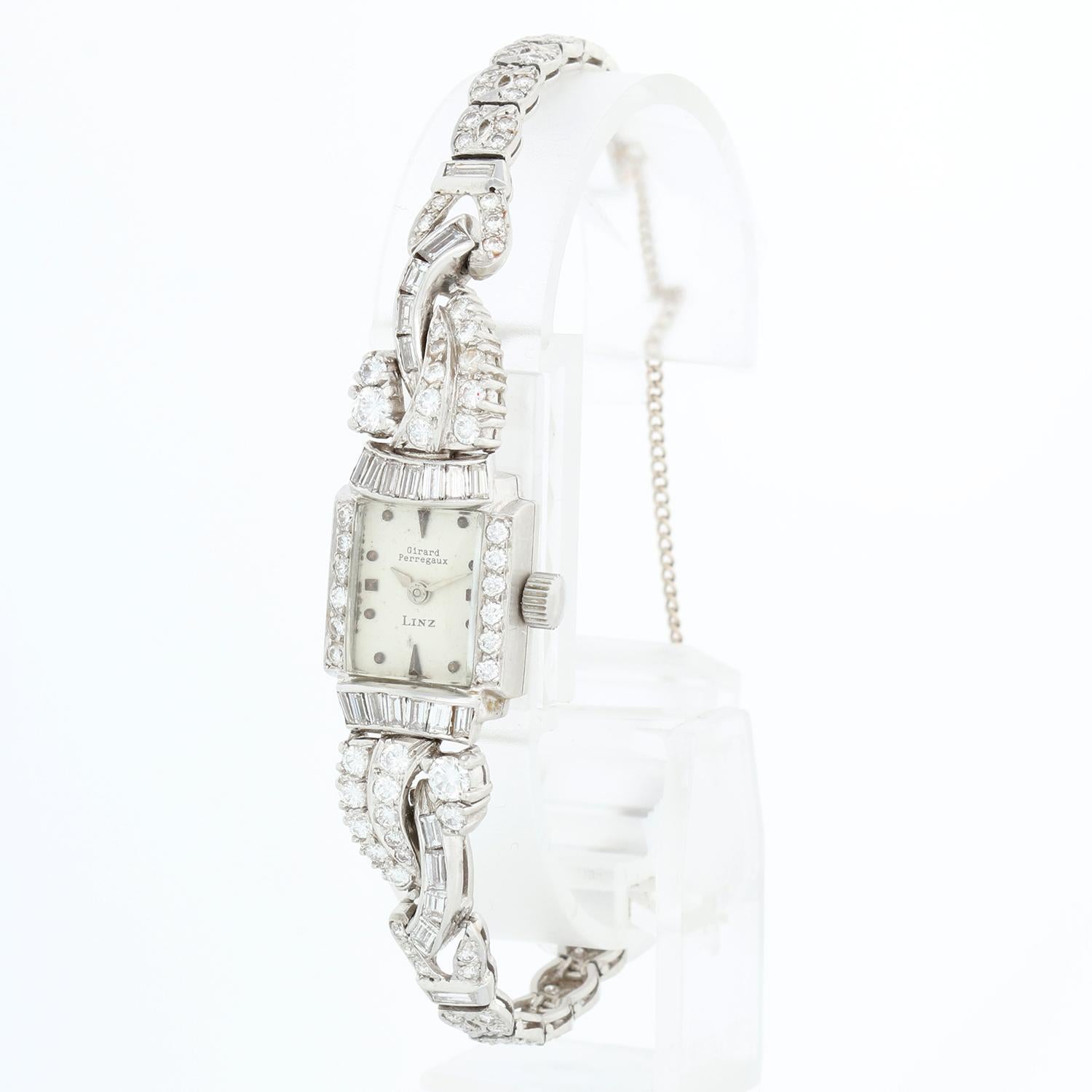 Girard-Perregaux Retailed by Linz Platinum Diamond Watch - Manual winding. Platinum with baguette diamonds and round diamonds  ( 14 x 20mm ). Silver dial with round hour markers. Platinum diamond bracelet; fits up to a 5 3/4 inch wrist. Pre-owned