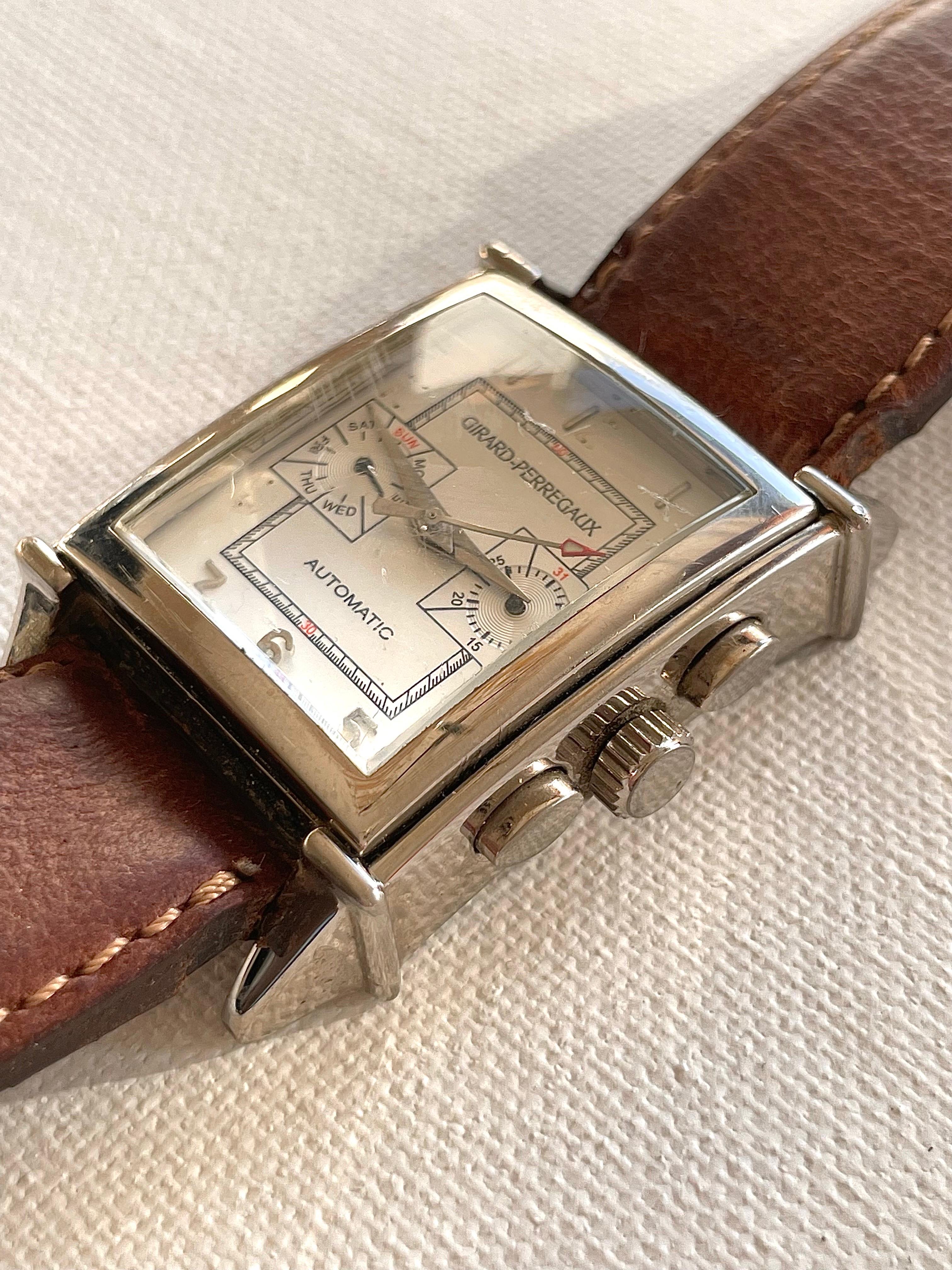 Beautiful collectors piece metal case chronograph wrist watch by Girard-Perregaux with time-date indication. OG number 21, building year 1999. This is a fully automatic watch working on the movement of the person wearing it. Brown leather strap with