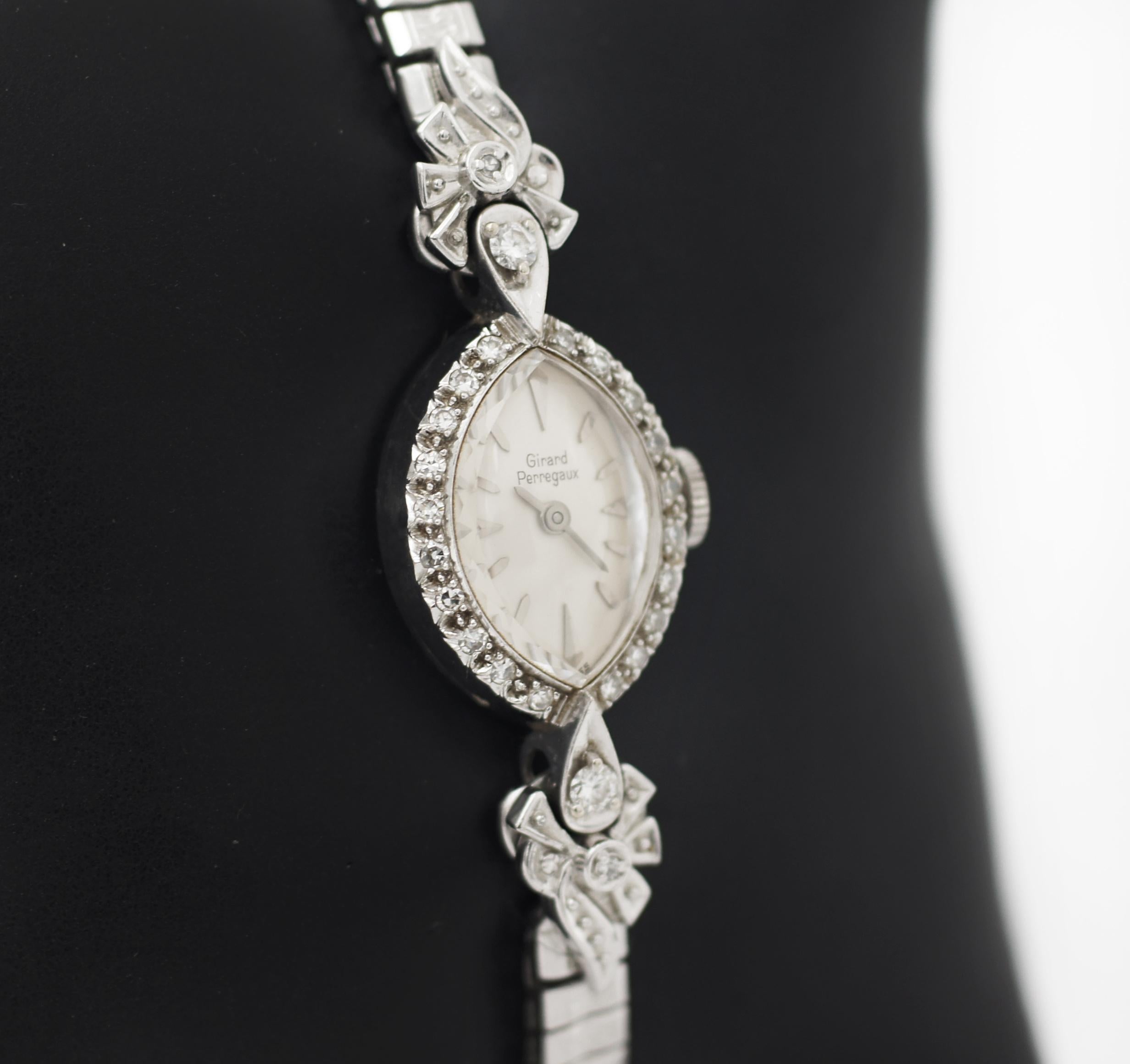Girard Perregaux
14K White Gold Case
Diamond Bezel and lugs
Approx. 15mm W x 20mm H case
Silver like dial and white gold markers and Hour and minute sweeping hands
Approx. 5 mm wide bracelet
Watch approx. 7