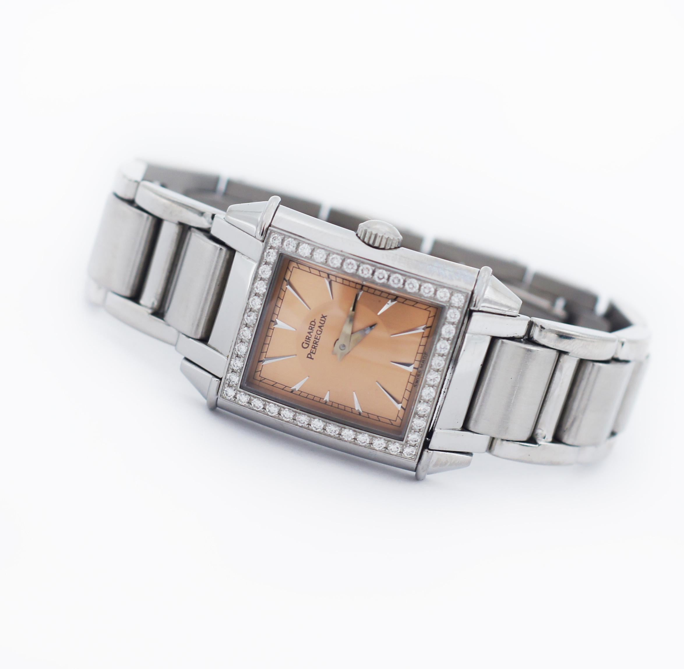 Girard Perregaux
Model Vintage 1945
Reference number 2592
Movement Quartz
Case material Stainless Steel
Case diameter Approx. 23 x 23.5 mm
Crystal Sapphire crystal
Dial Pink/ Salmon
Stainless Steel Markers
Single Row Diamond bezel
Bracelet material