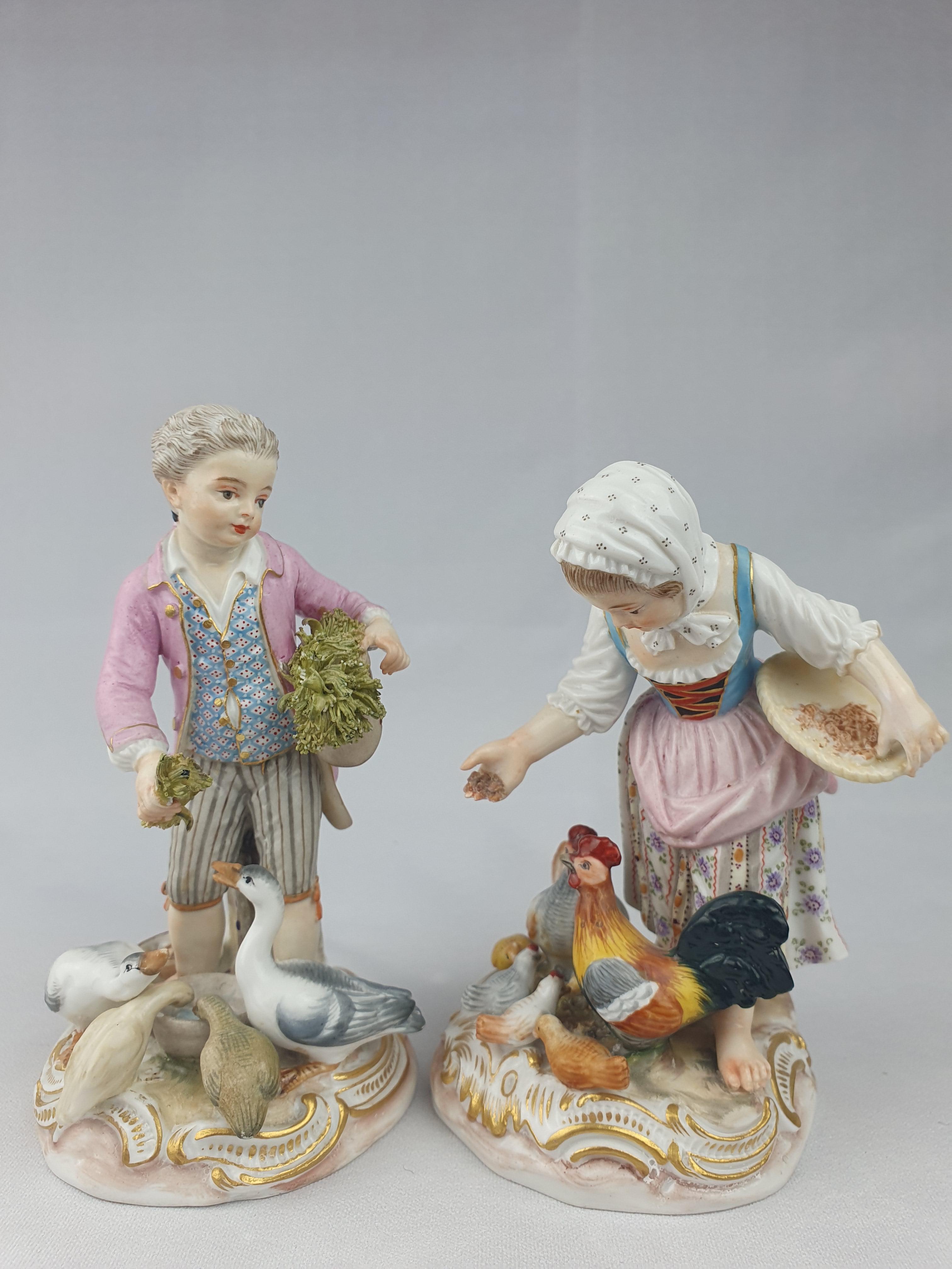 Pair of Meissen Figures. The girl feeding chickens, the boy feeding geese. The pair first modelled by J.J Kaendler in 1761.
This pair circa 1870.

Both figures with underglaze blue cross-swords. Matching painters numbers 64 in red.
Height of