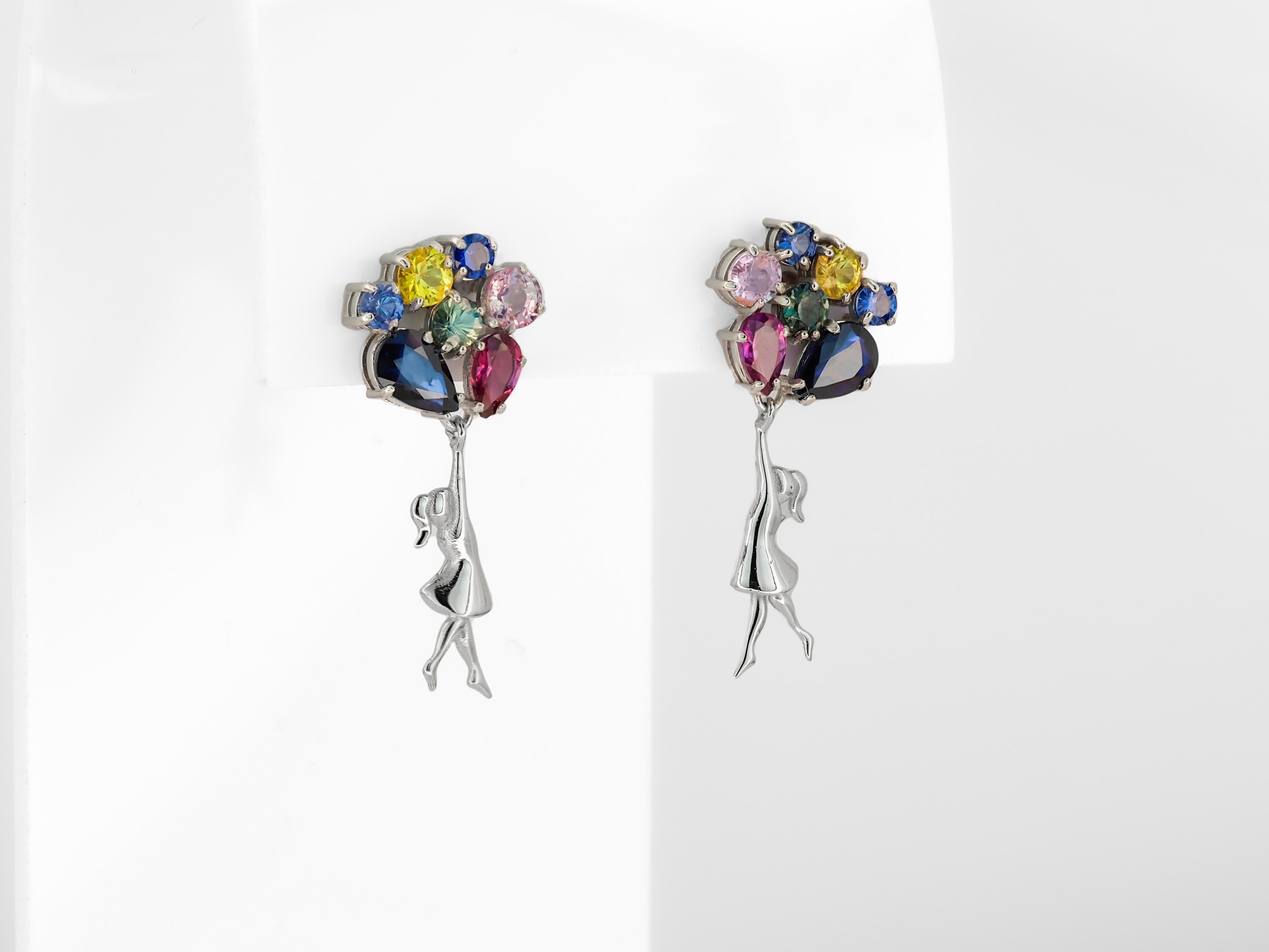 Banksy inspired Girl on balloons earrings with multicolor natural gemstones. Contemporary design earrings.

14k solid gold
Weight: 3.20 g.
Size: 25 х 7 mm.
Gemstones:
Blue sapphires: 2 pieces, 5 x 4 mm each - 1.20 ct total weight, blue violet color,