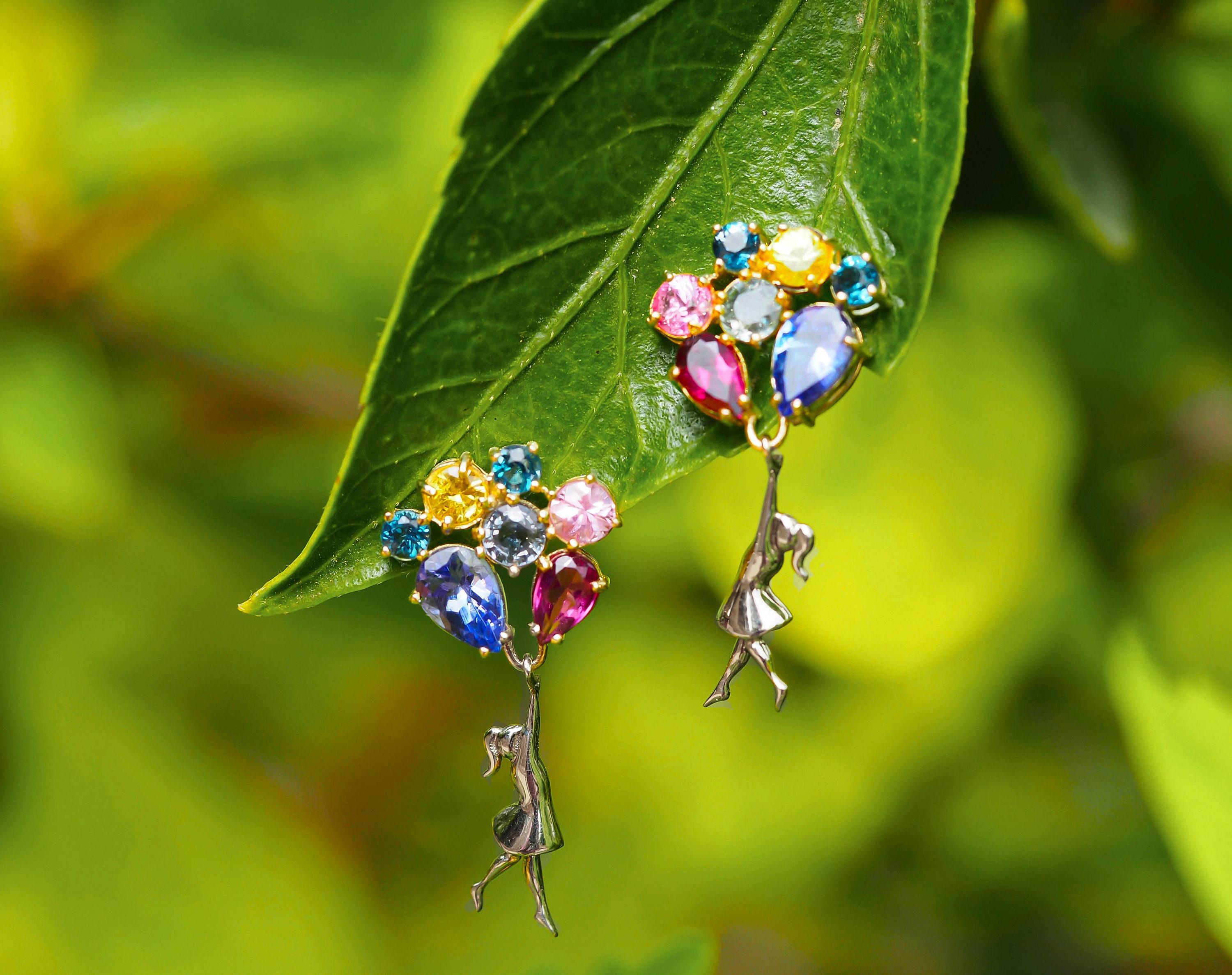 Banksy Inspired Girl with Balloons Earrings studs in 925 silver.

Metal type: 925 silver
Size: 25 x 7 mm.
Weight: 3 g.

2 sapphires - blue violet color, pear cut, transparent, 6x4 mm each - 1.8 ct total weight
2 garnets - purplish red color, pear