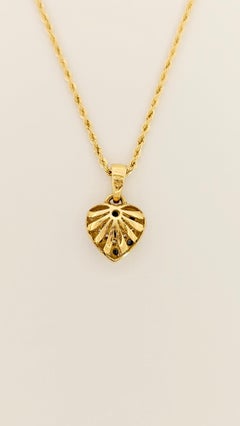 Halskette aus 18 Karat Gold mit Herzanhänger aus Diamanten und blauen Saphiren