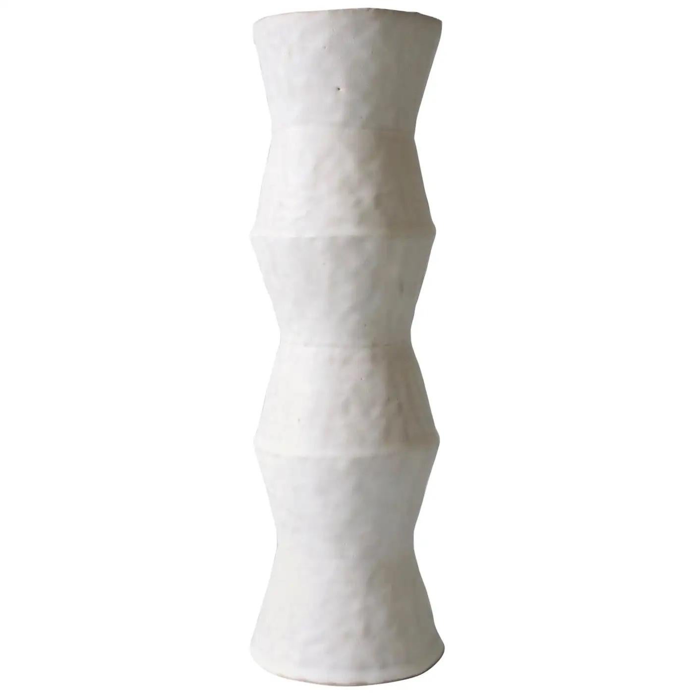 Contemporary American ceramic artist Giselle Hicks' glazed white stoneware vase is part of her Vessel Series. Each form is built by hand using a coil and pinch technique. They are formal explorations in shape, volume, color and composition. The