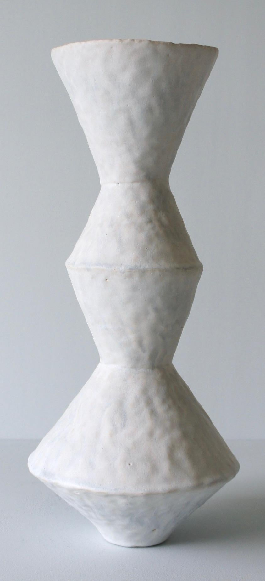 Contemporary American ceramic artist Giselle Hicks' glazed pale grey stoneware vase is part of her Vessel series. Each form is built by hand using a coil and pinch technique. They are formal explorations in shape, volume, color and composition. The