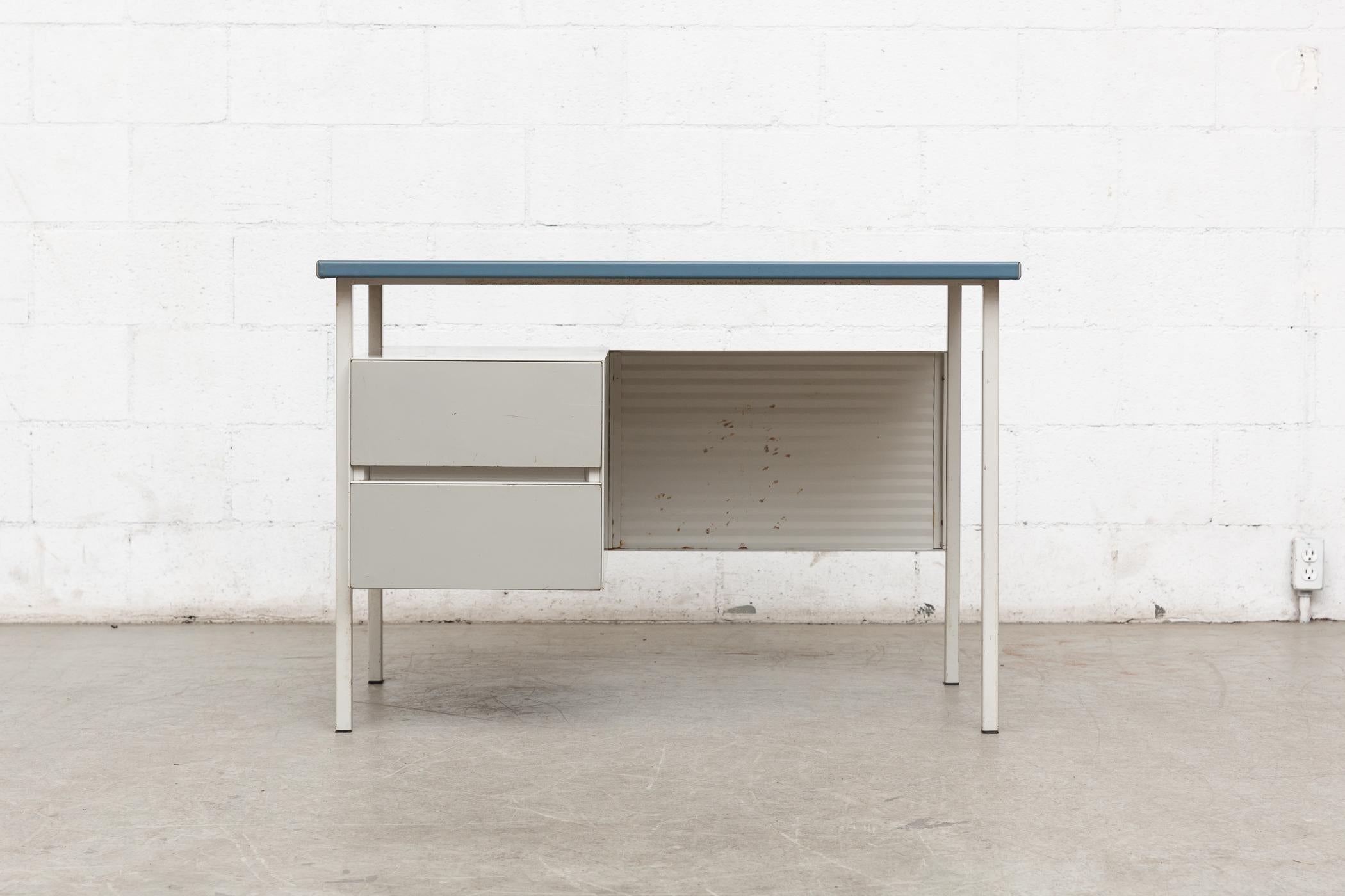 Gispen model 3803 by A.R. Cordemeyer. Cute little light grey enameled metal desk with matching enameled corrugated privacy screen and blue vinyl wrapped top and grey enameled drawer faces. Original condition with some wear and surface rust to metal