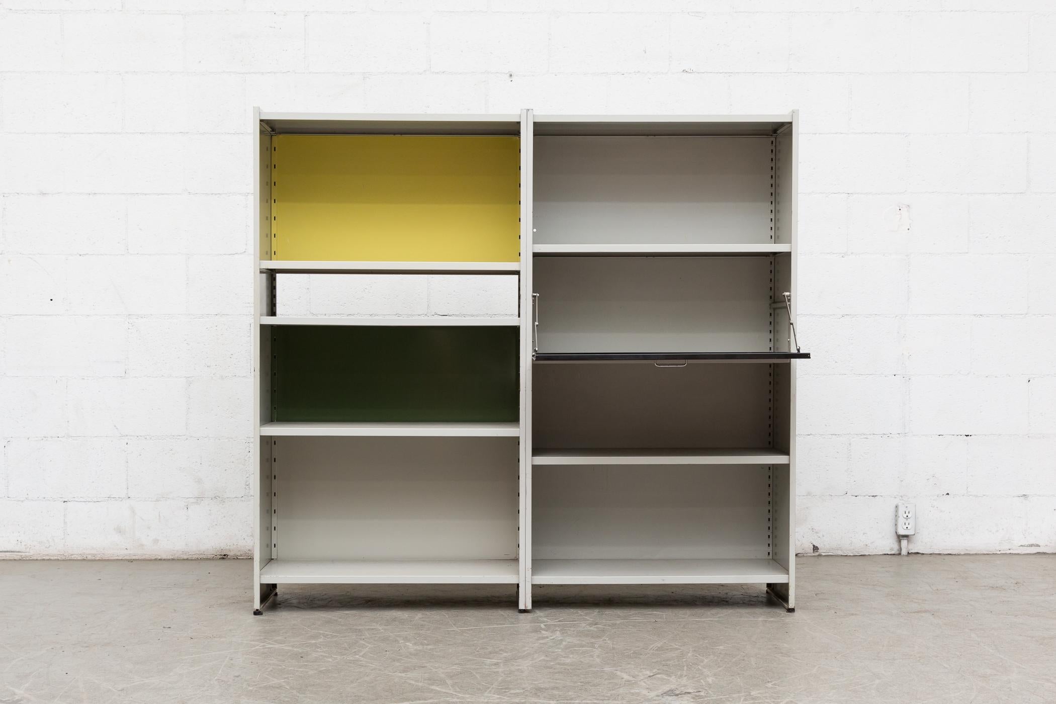 Amazing Gispen 5600 bookshelf by A.R. Cordemeyer. Grey enameled metal two-section industrial bookshelf and storage unit with drop down desk, black, yellow and green enameled metal panels. Can be used as a room divider, beautiful Eames inspired 360