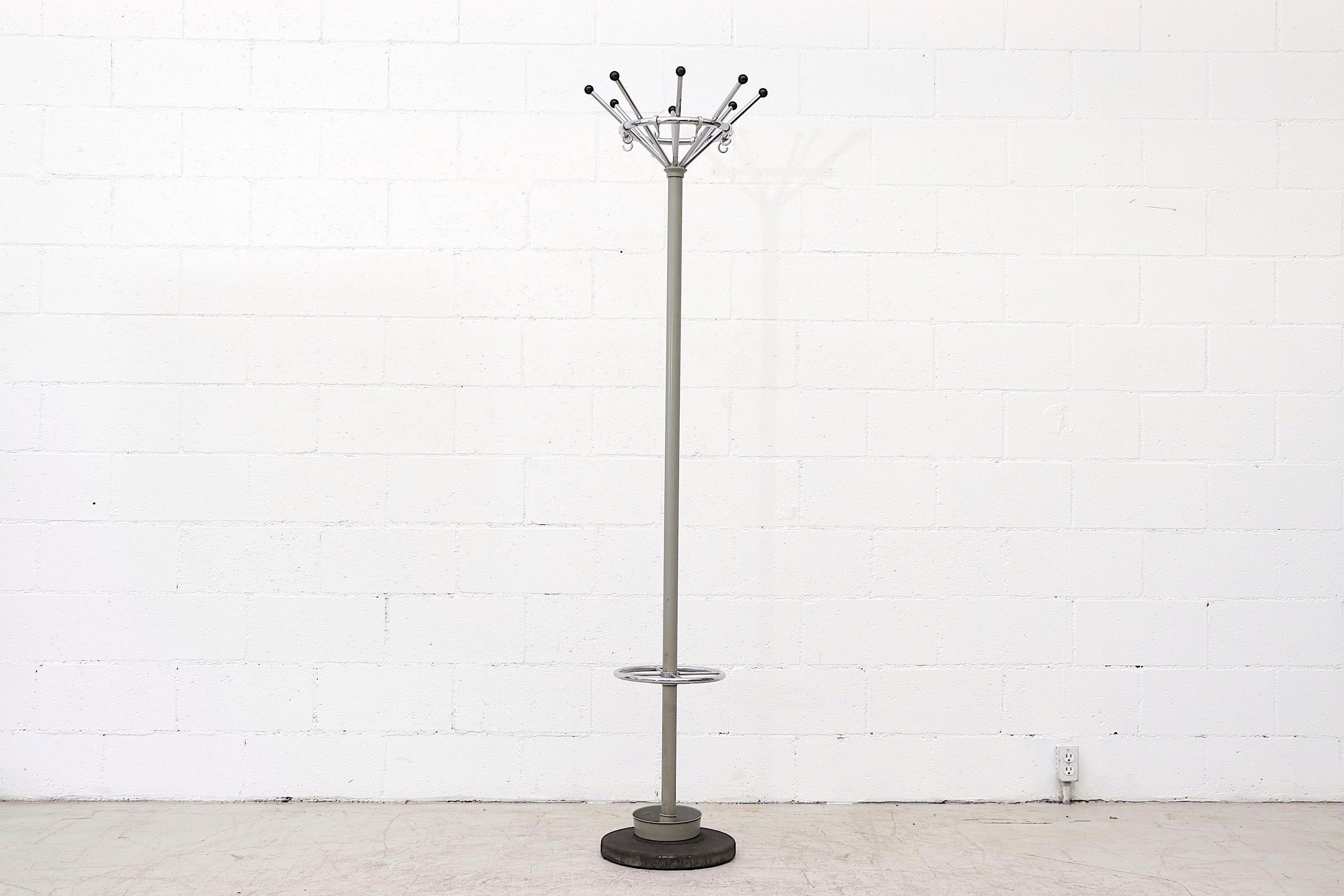 Gispen chrome Industrial coat tree with grey metal umbrella cup and black enameled weighted base. Top part has 8 Tubular arms with black synthetic knobs for coats and hats, below is an umbrella holder. In original condition with some surface rust.