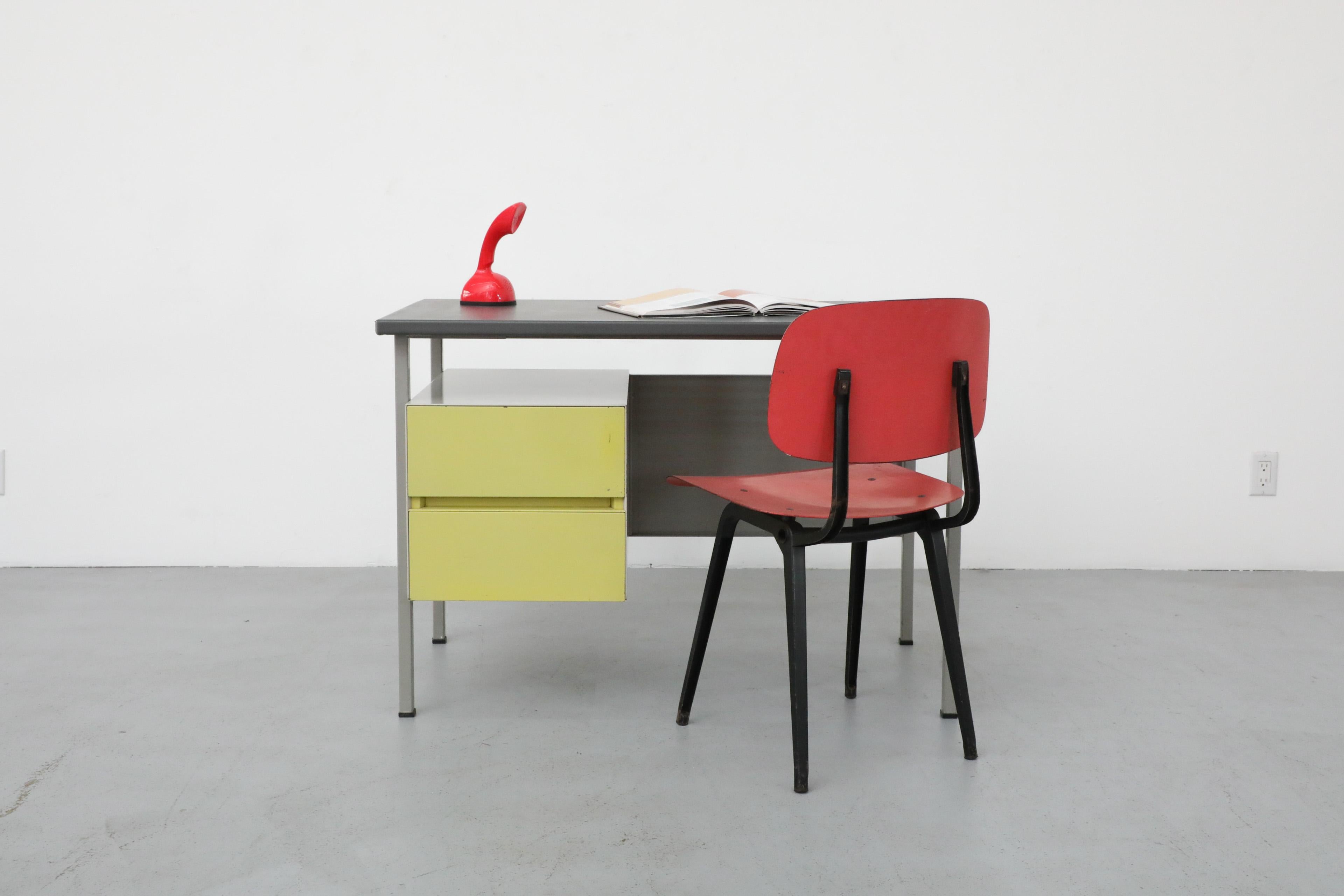 Mid-Century chartreuse enameled industrial desk designed by designer A.R. Cordemeijer for famed Dutch manufacturer Gispen. This stylish 1960s desk has a single cabinet with two chartreuse enameled doors, a metal privacy screen and gray linoleum top.