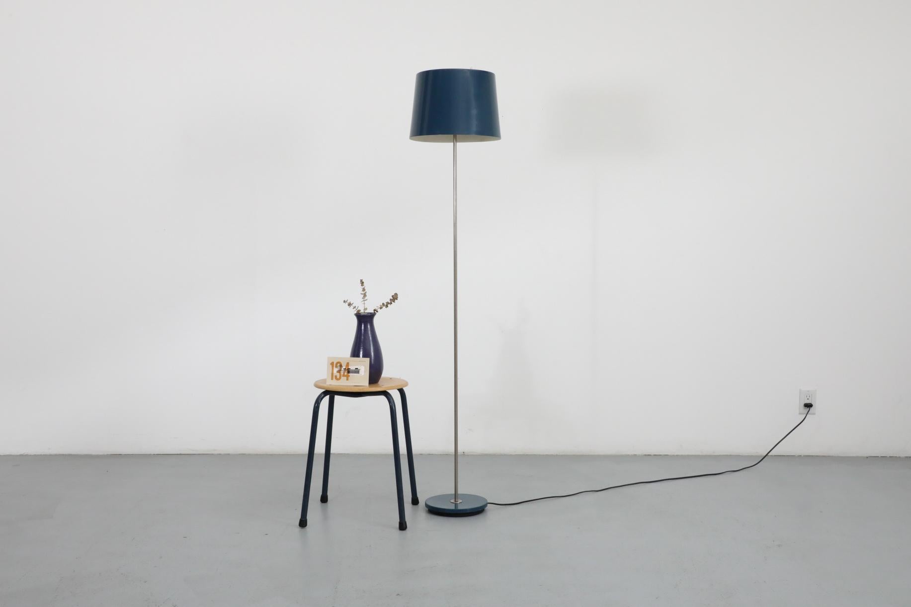 Classically proportioned floor lamp with a muted blue enameled metal shade and base with chrome stem. Great industrial design that would fit nicely in a Modern or Mid-Century setting visible wear and scratching to enamel as well as patina to the