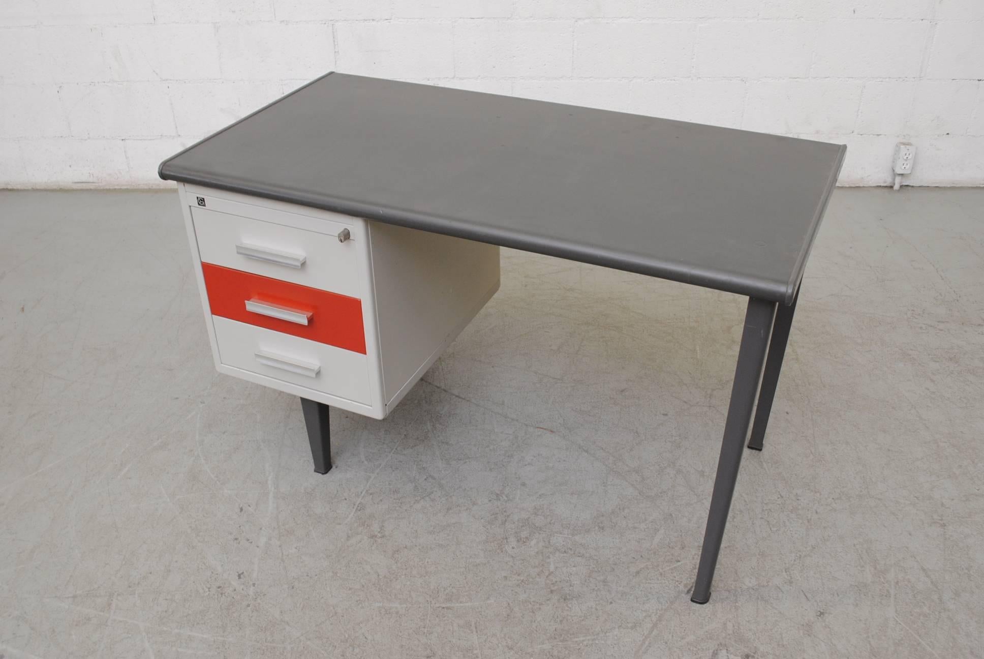 Rare Gispen Industrial desk with red enameled metal drawer and linoleum top. Three sliding drawers. Original condition with visible wear. Has key.