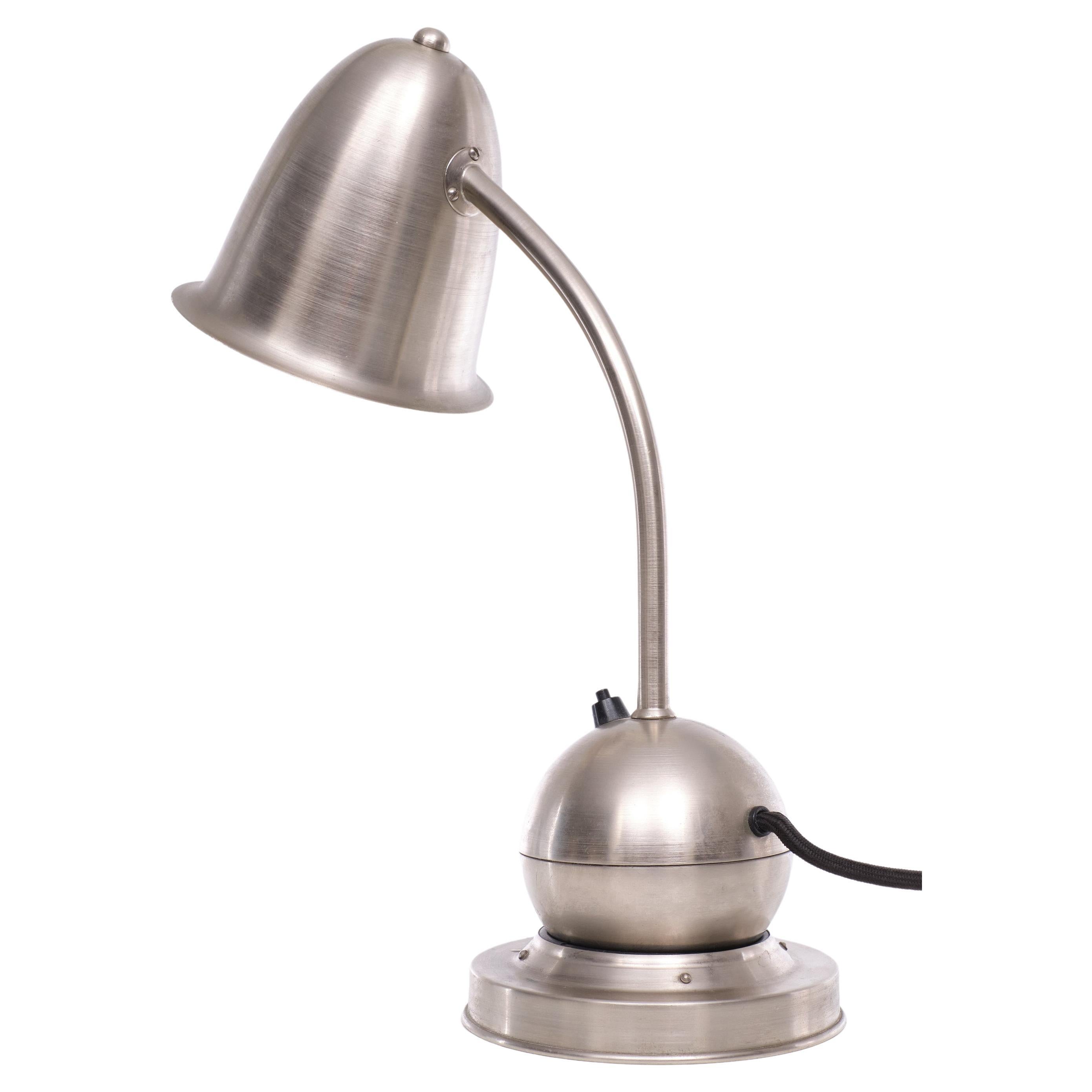Very nice desklamp Called The Tumbler ''De Tuimelaar ''Produced by 
Daalderop, circa 1928 The design has been attributed to the influential 
Dutch modernist W.H. Gispen 
Its bell shaped shade can be positioned any way you like, for it is counter